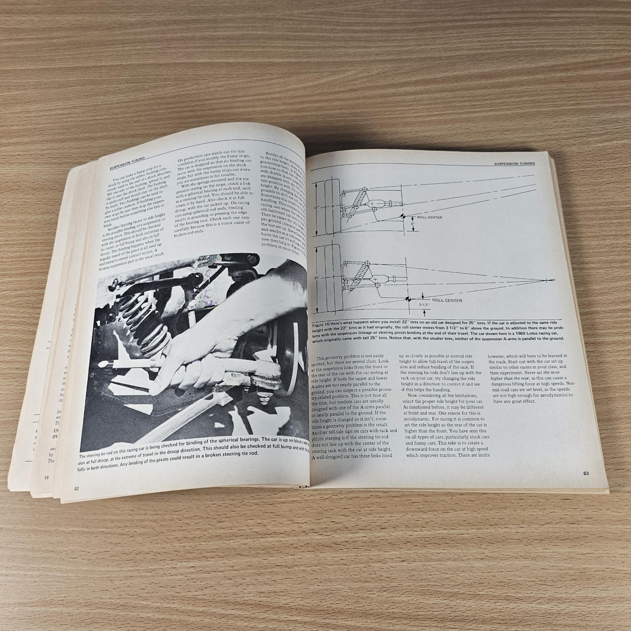 Open car handling guidebook with grayscale mechanical photo and line diagrams