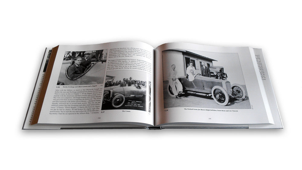 Open racing book with black-and-white car photos on printed pages