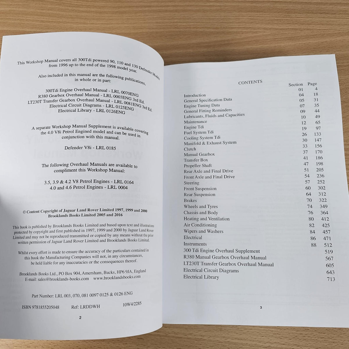 Workshop manual open to contents pages with section list and page numbers