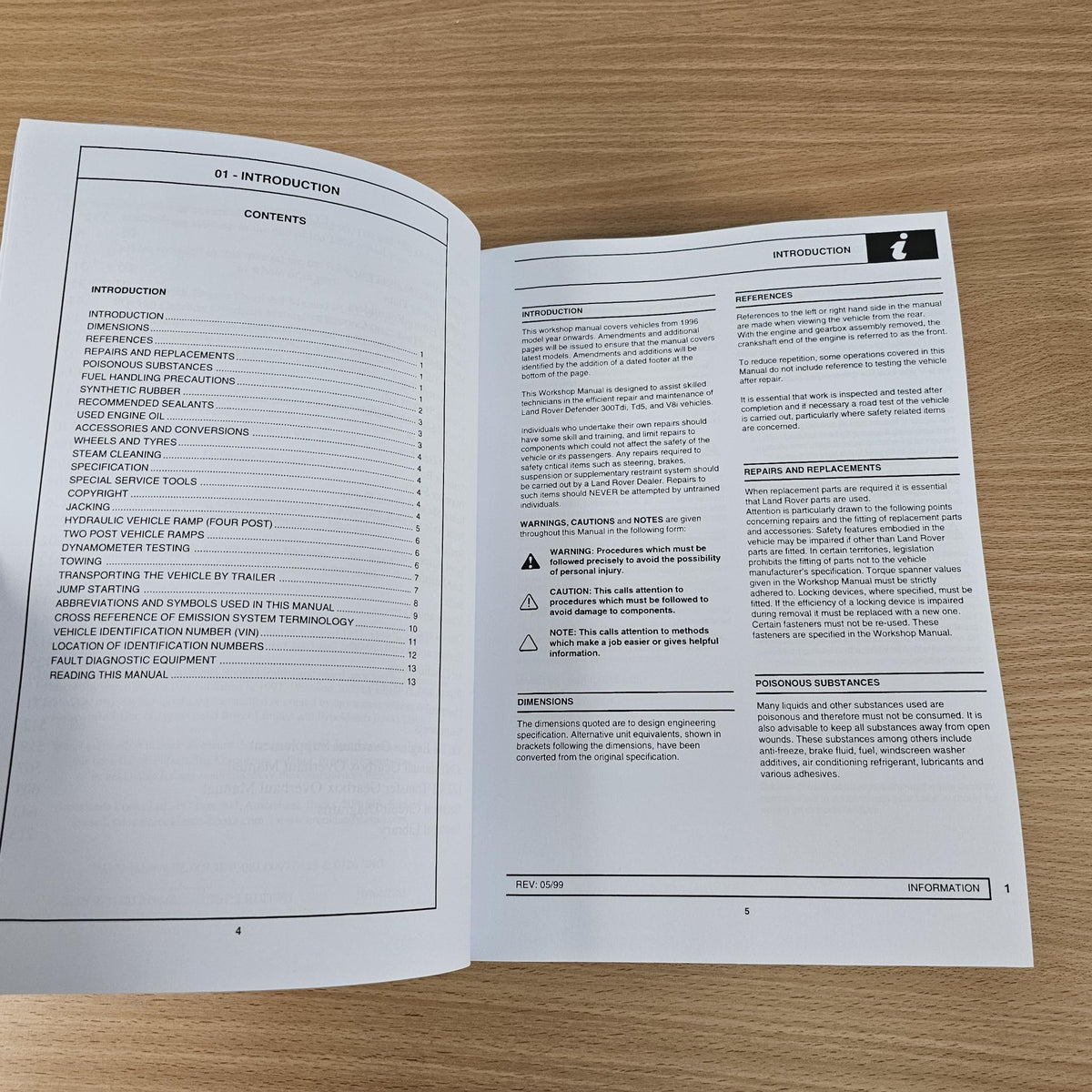 Workshop manual open to introduction pages with contents and warning callouts