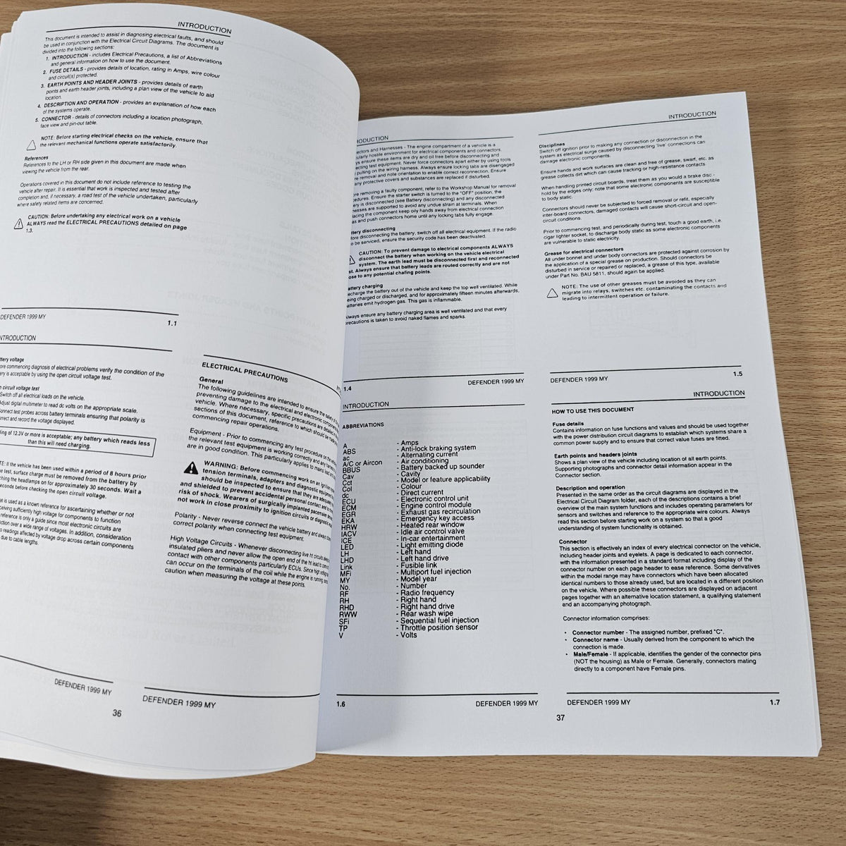Open electrical manual pages with detailed text and section headings