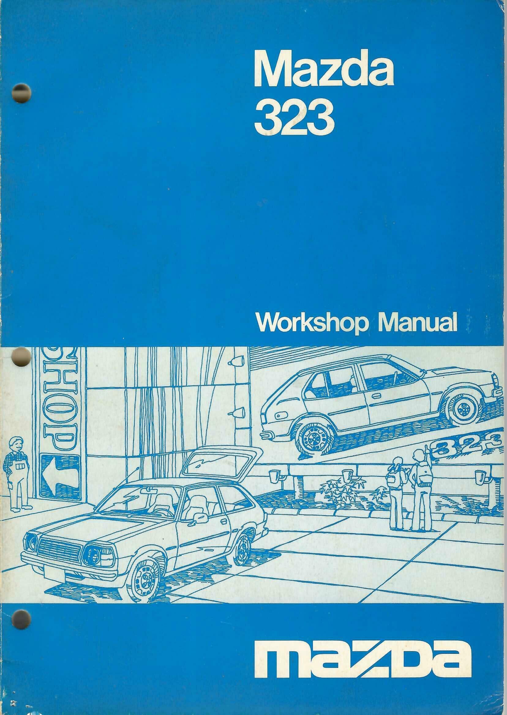 Mazda 323 workshop manual paperback, blue cover with car illustration and title
