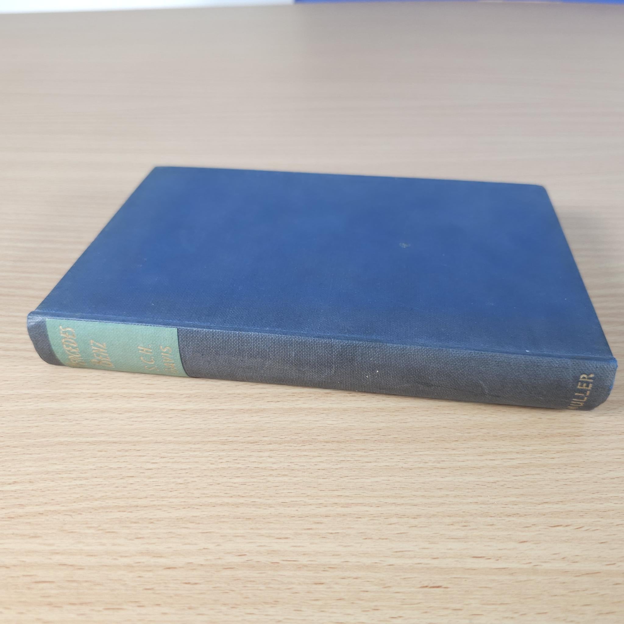 Blue cloth Mercedes-Benz S. C. H. Davis hardcover book on wood surface