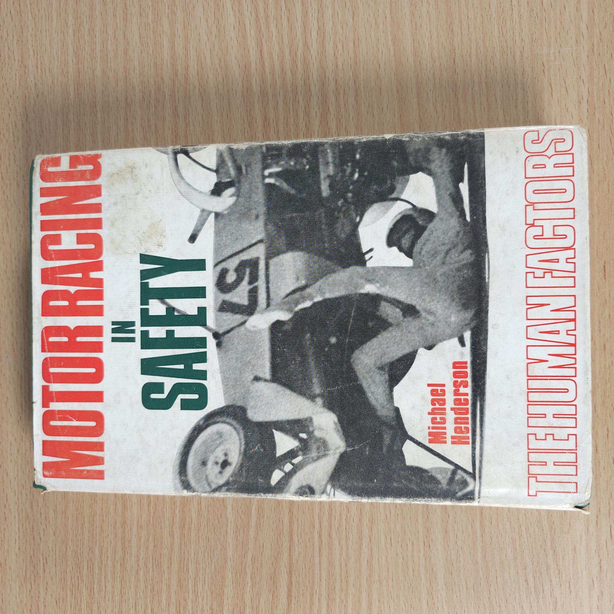 Vintage motorsport safety book front cover with red, green, and black typography