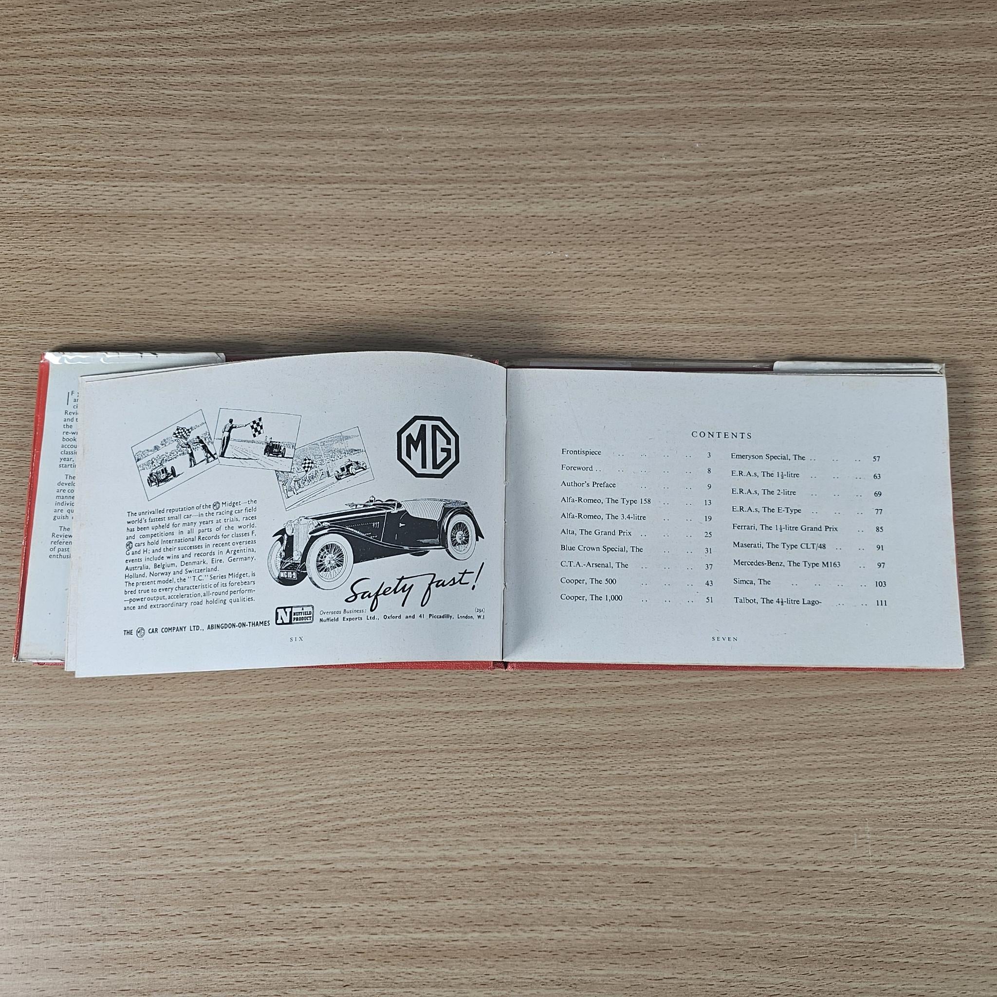 Open vintage book with MG logo on left page and safety diagram; right page list.