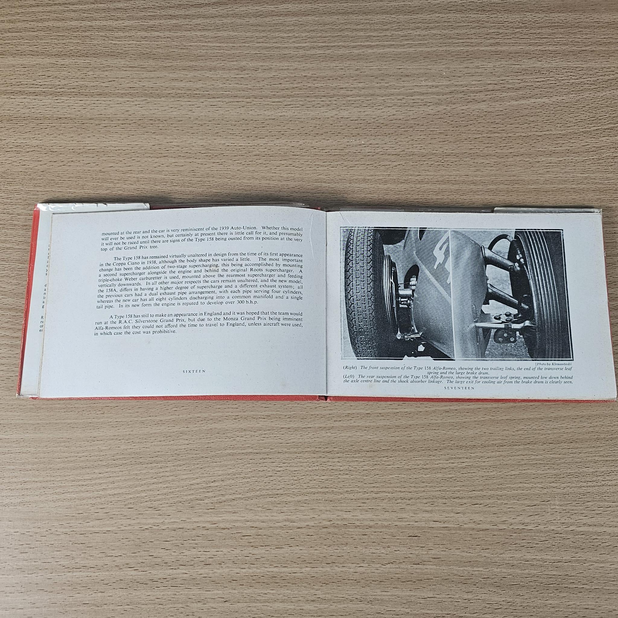 Open vintage book with dense text on both pages and a black-and-white car detail photo.