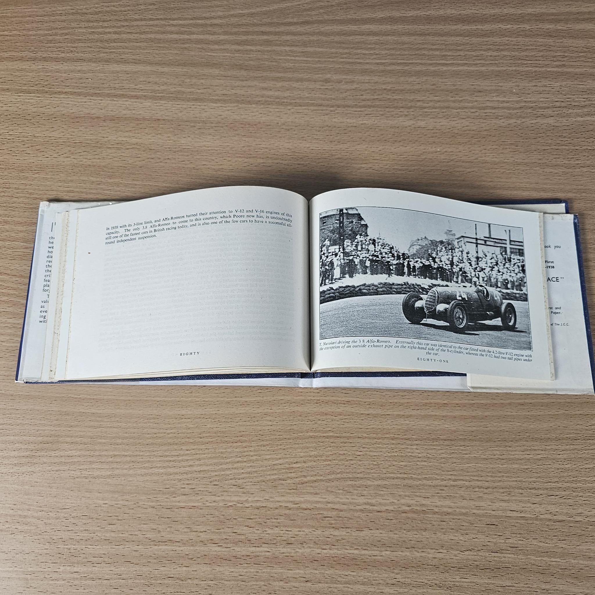 Open racing book with black-and-white photo of a vintage car on right page