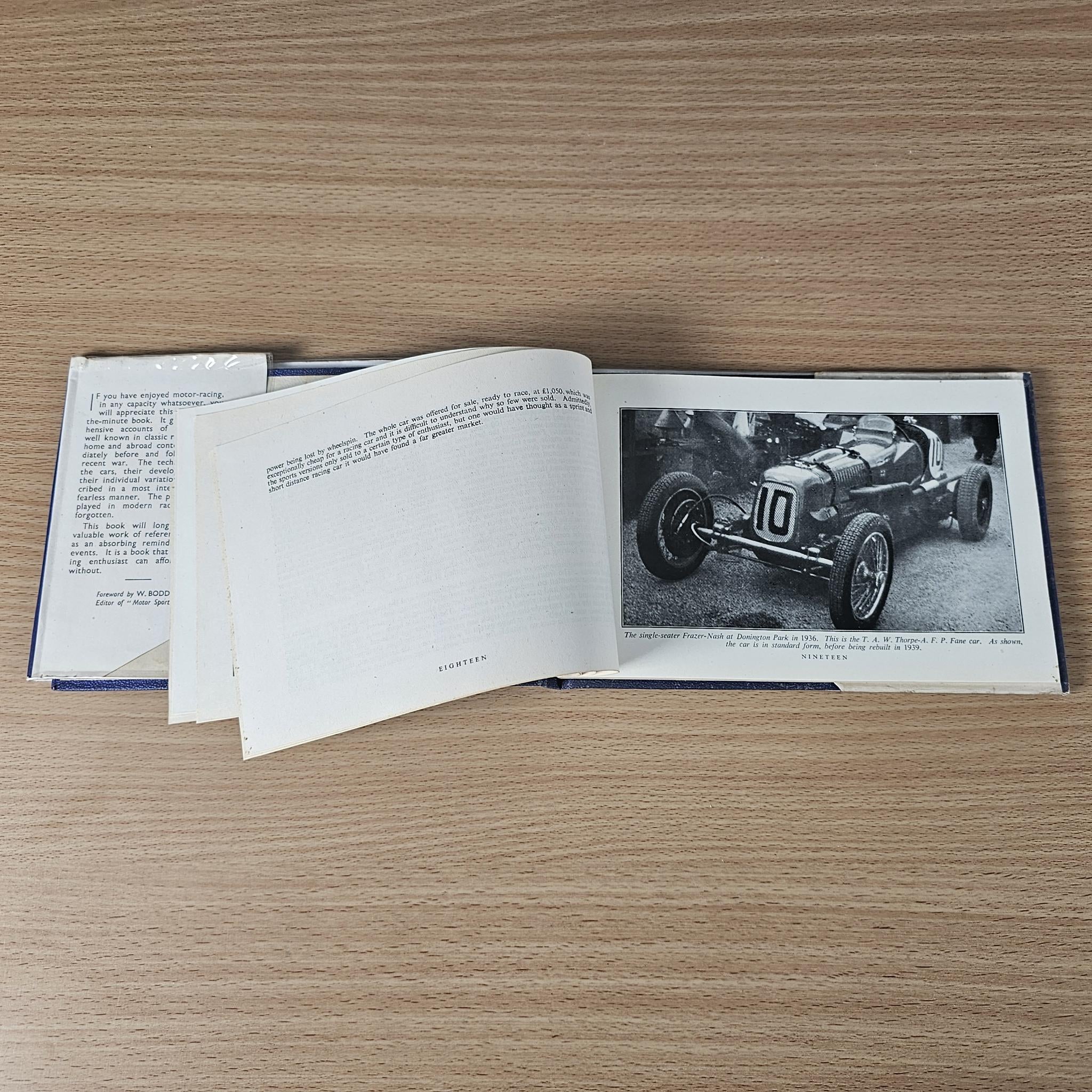 Racing car review book open with racing photo panel on the right and text on left