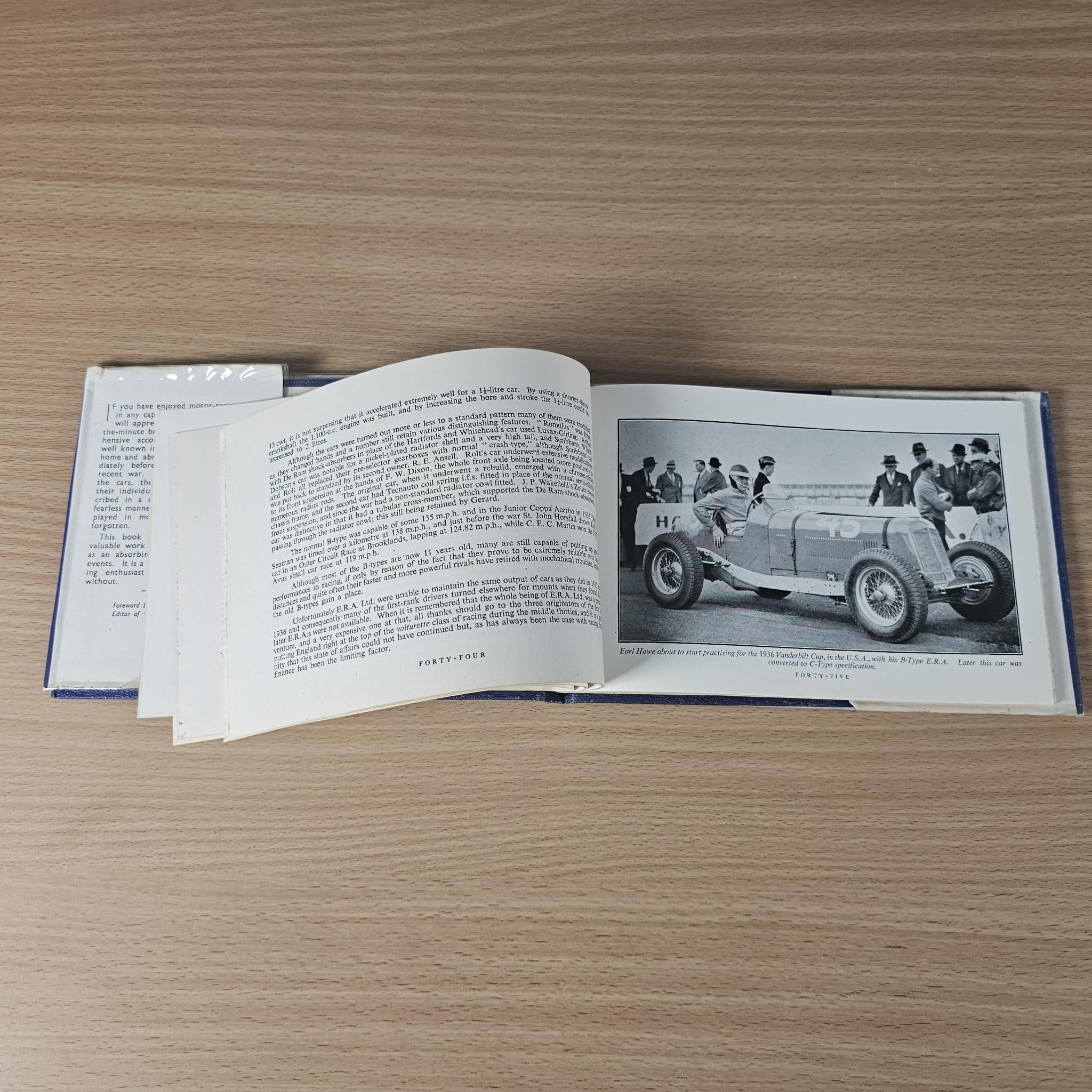 Racing car review book open, text on left with a car action photo on the right
