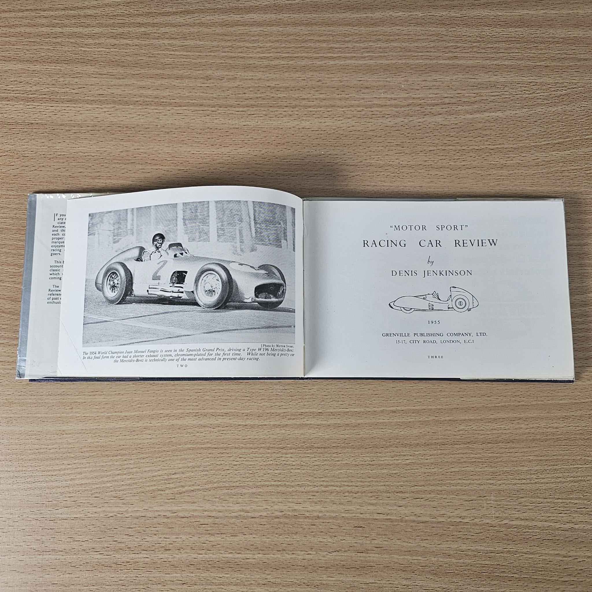 Open vintage racing car review book with race car photo and Denis Jenkinson
