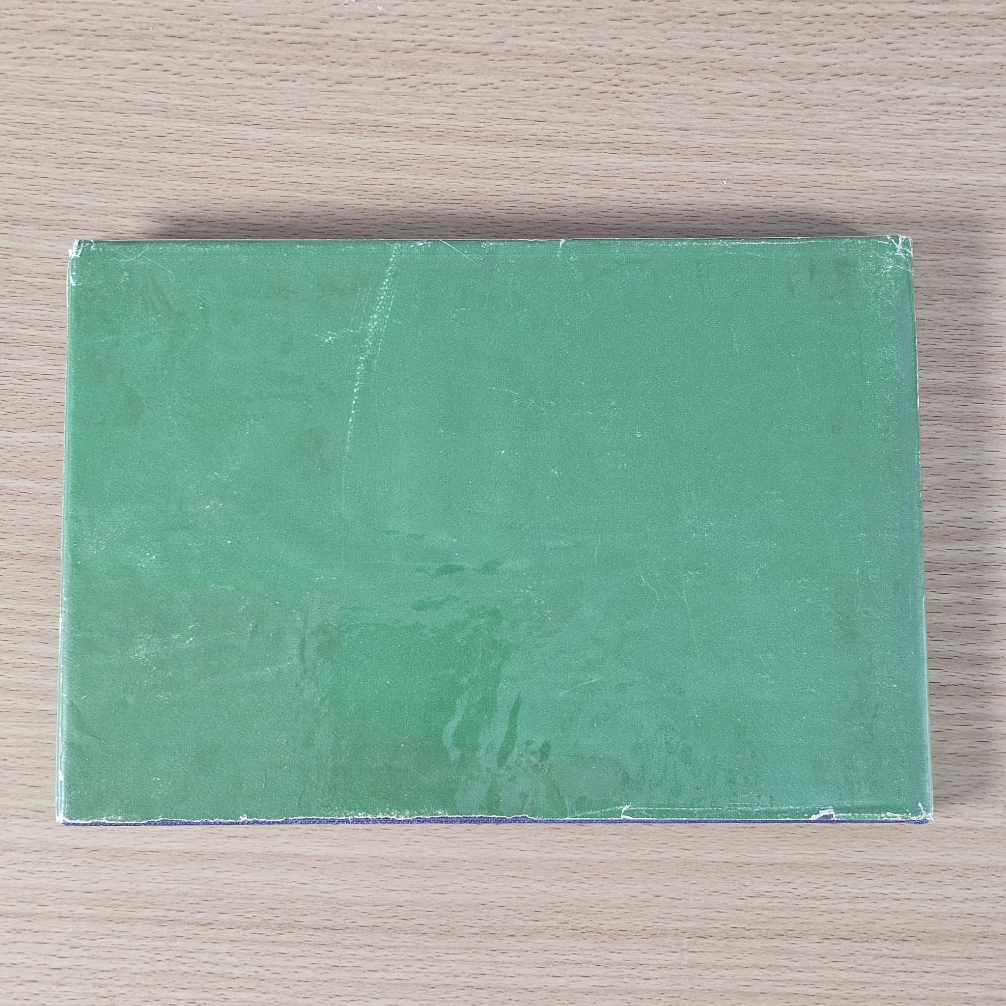 Vintage racing car review book, green back cover with worn texture and pale border