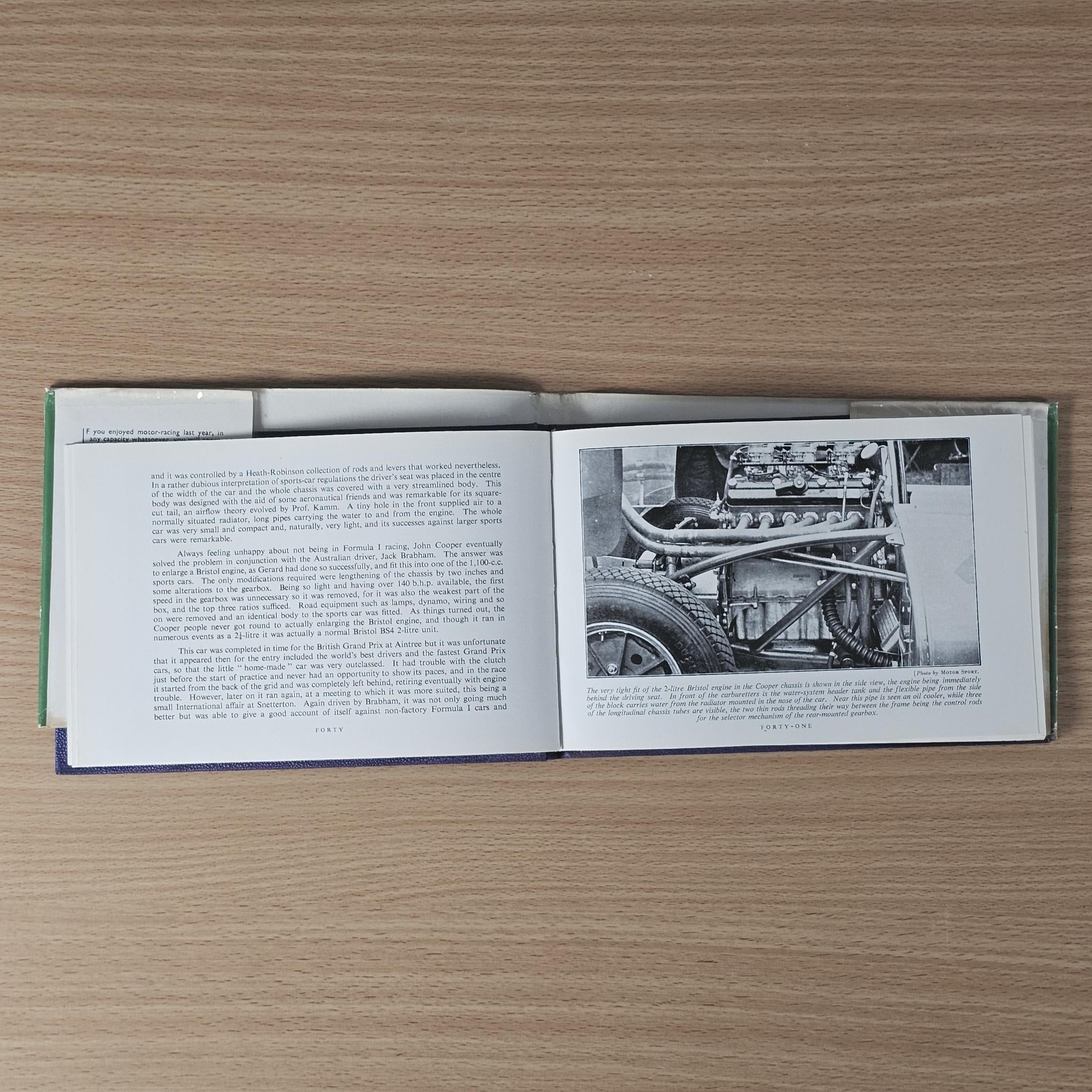Vintage racing car review book, open spread with article text and chassis component photo