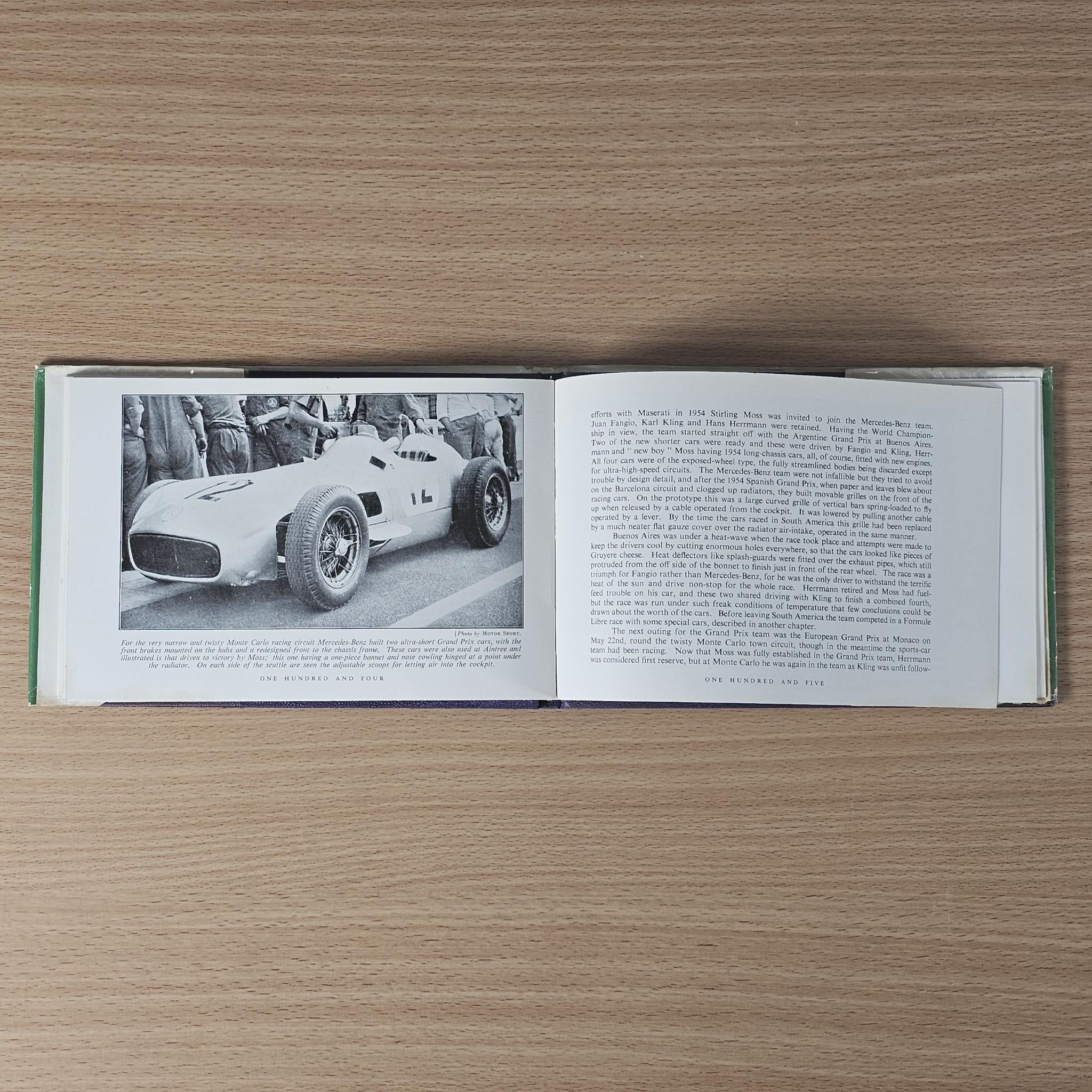 Vintage racing car review book, open spread with side-view race car photo and paragraphs