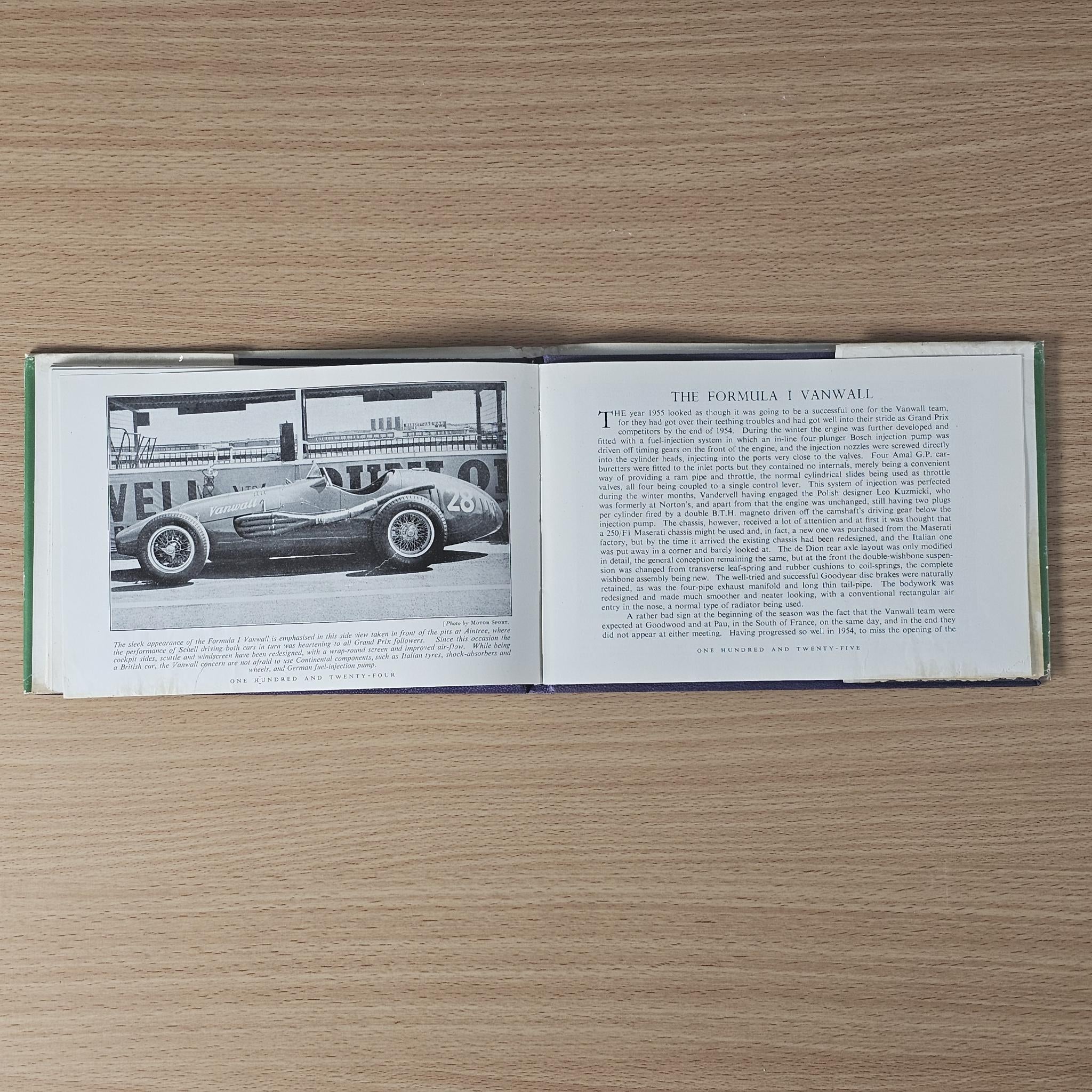 Vintage racing car review book, open spread with race car diagram and paragraph text
