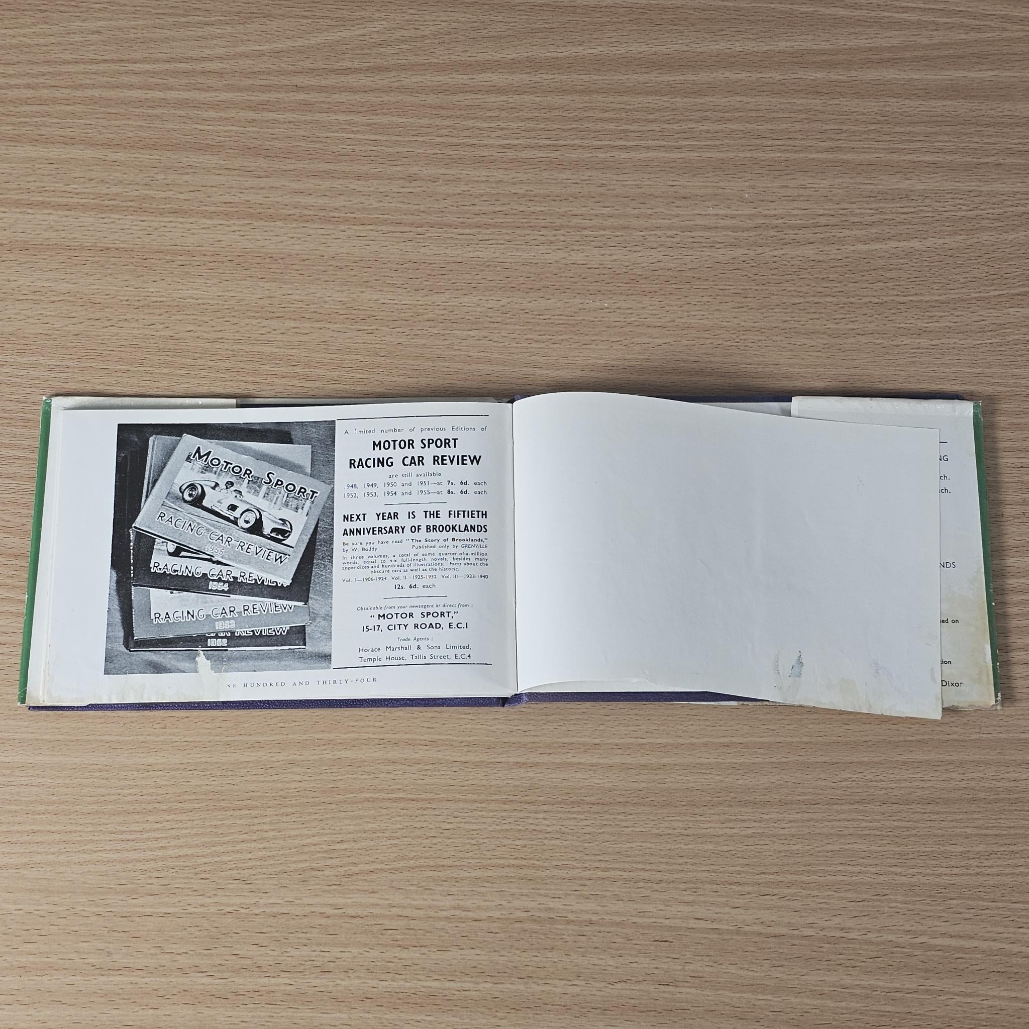 Vintage racing car review book, open pages with racing review layout and headings