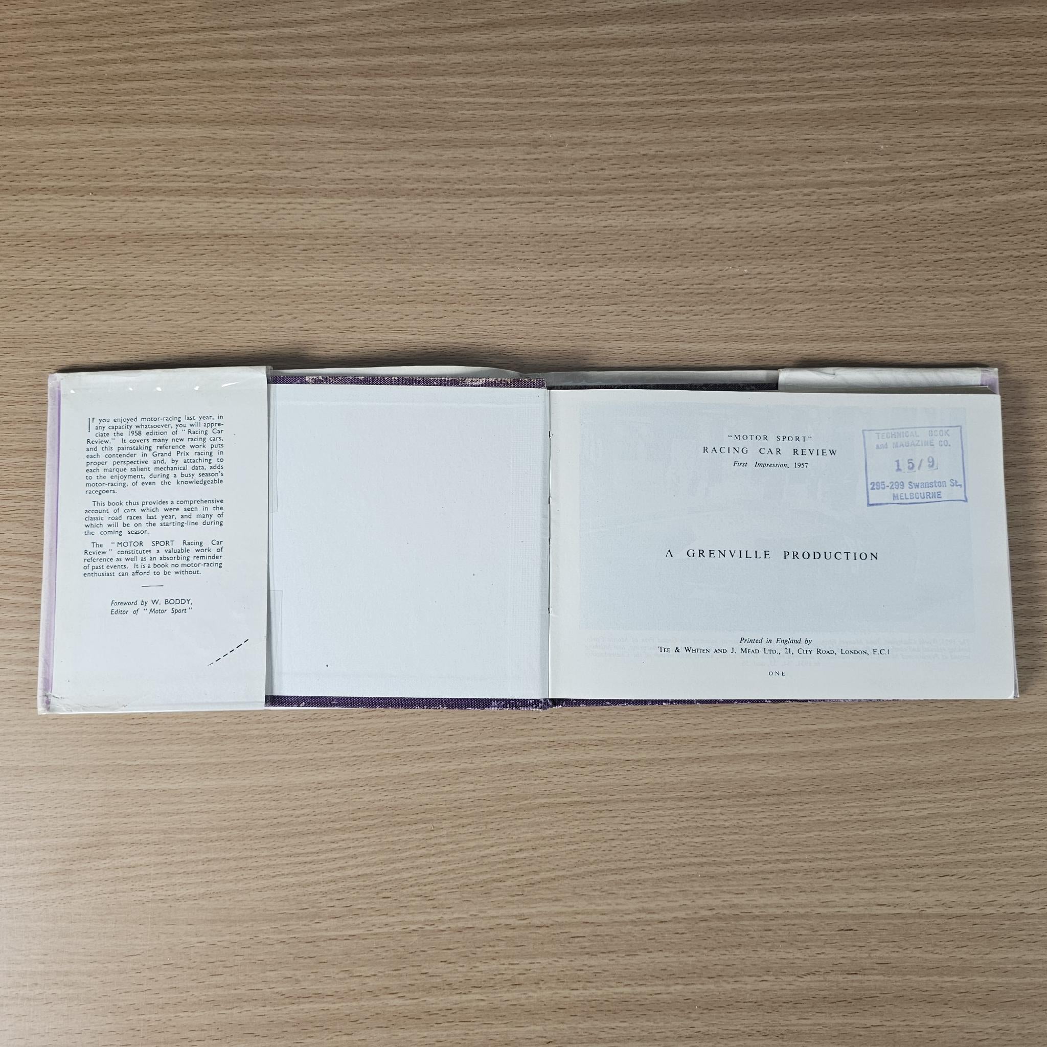Open 1958 racing car review book showing left text, blank center page, and title page