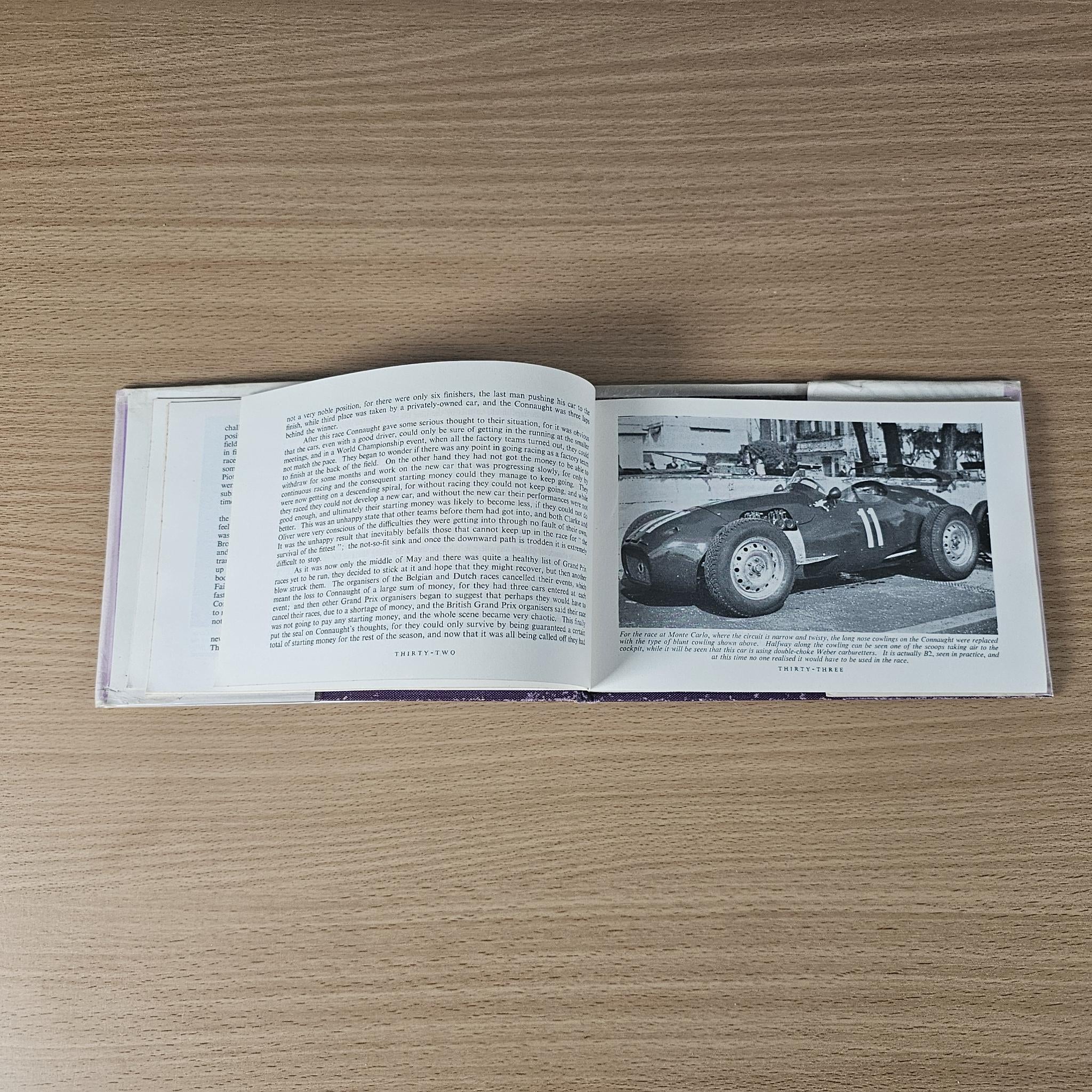 Open 1958 racing car review book with text and black-and-white photo of a race car