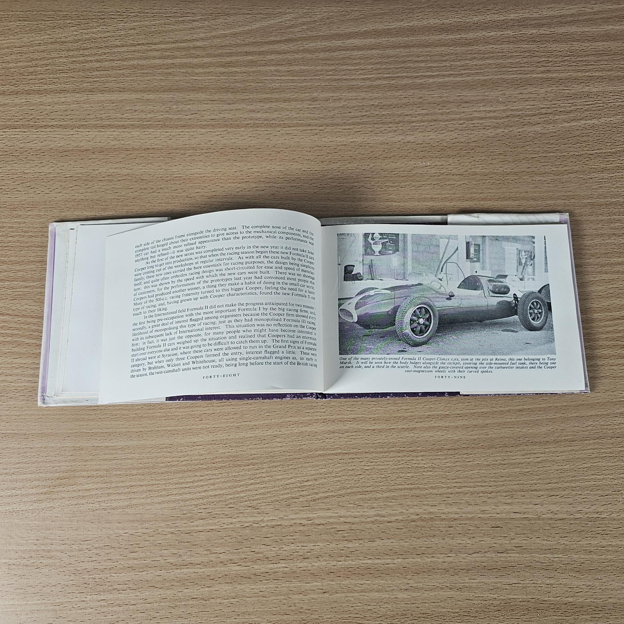 Open 1958 racing car review book with text and black-and-white photo of a race car