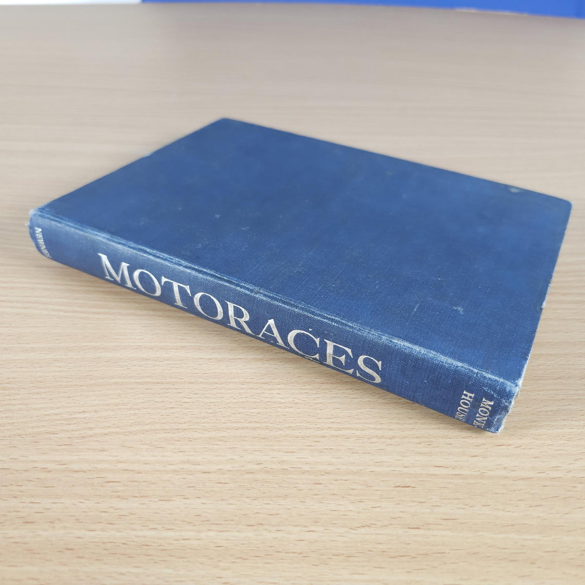 Vintage racing book with blue hardcover and title stamped along front edge