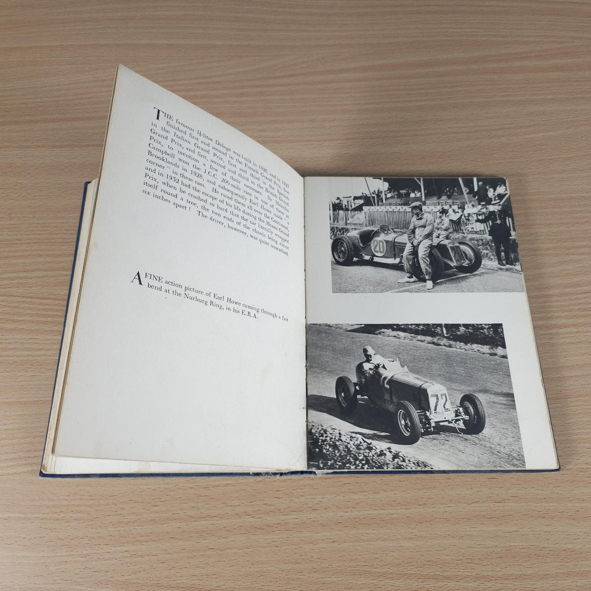 Vintage racing book, open pages with black-and-white car photos and printed text