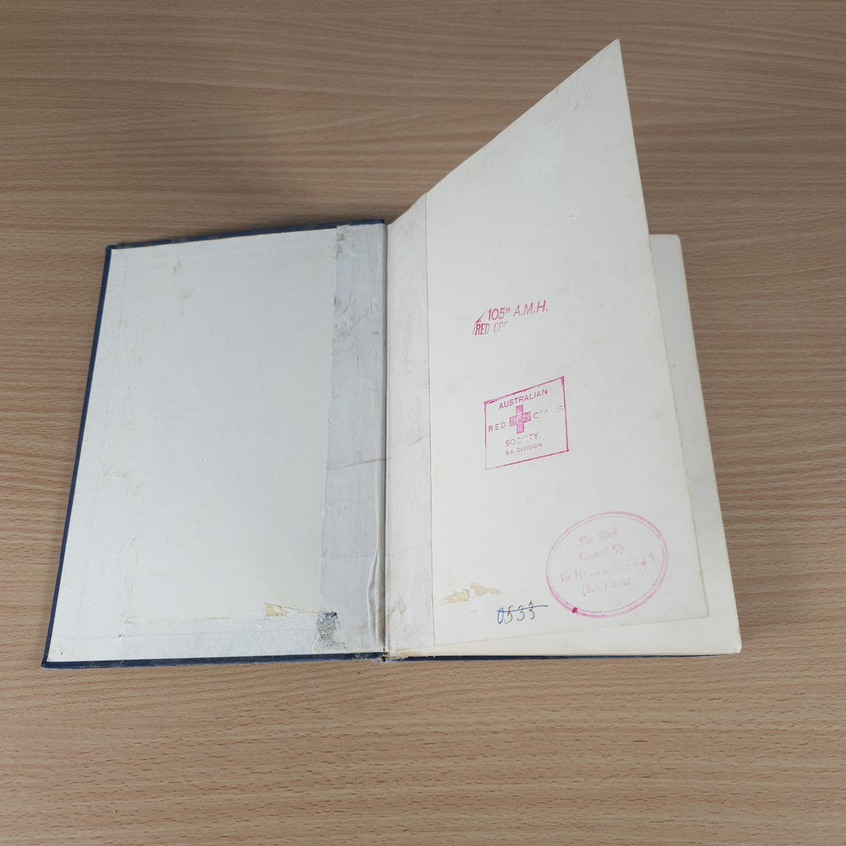 Vintage racing book, open at back with red stamps and handwritten notes on inside cover