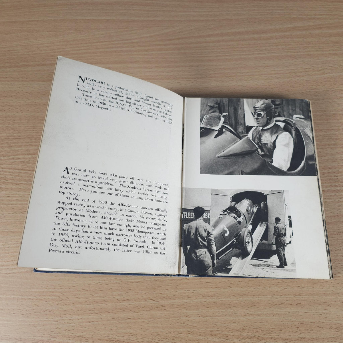 Vintage racing book open, with text pages and black-and-white action photos near cars
