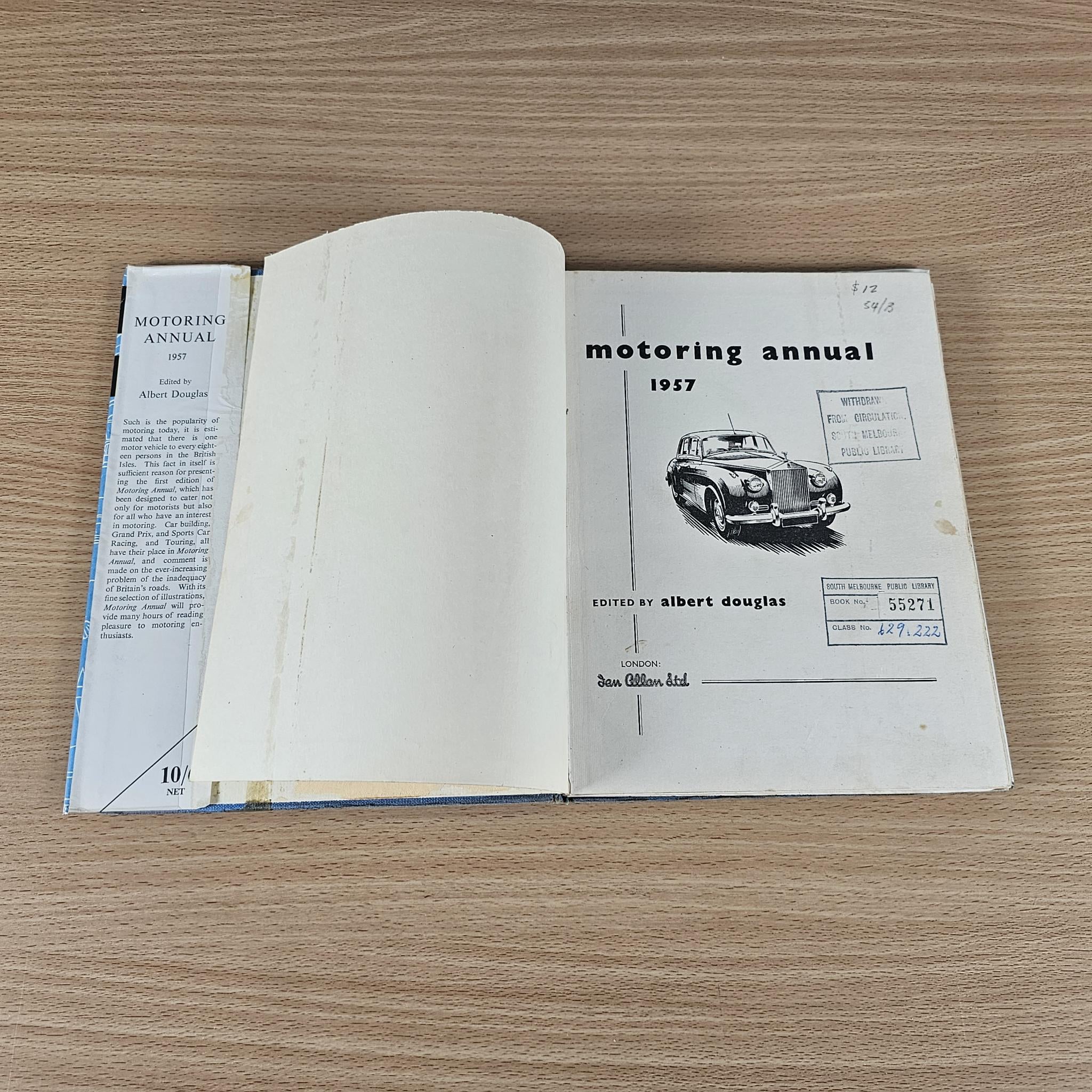 Motoring Annual open book showing 1957 cover page and vintage car illustration