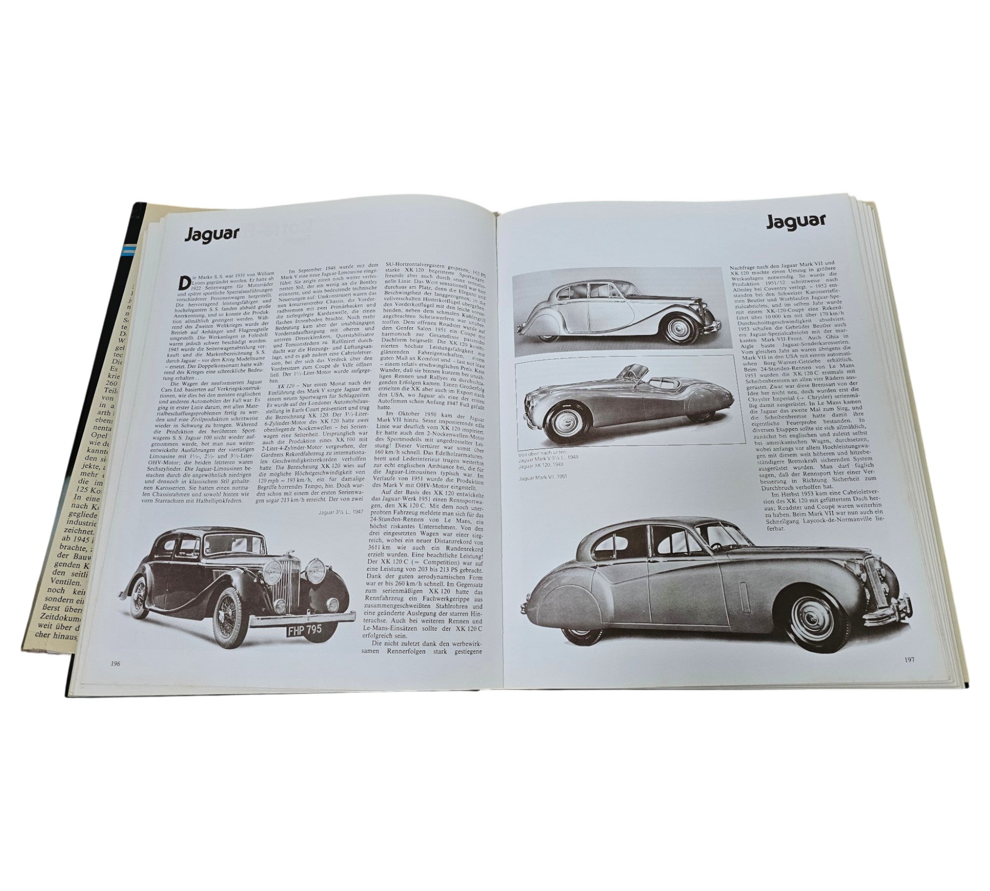 Postwar passenger car book open featuring Jaguar pages with car photos