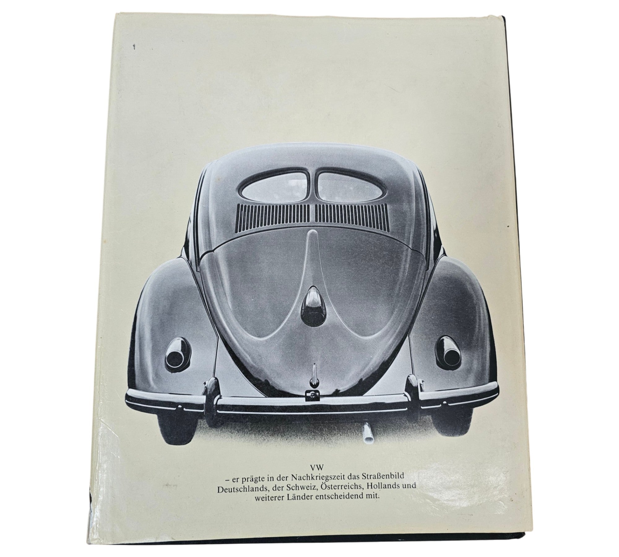 Vintage automotive book, open pages with brown cover and narrow text column