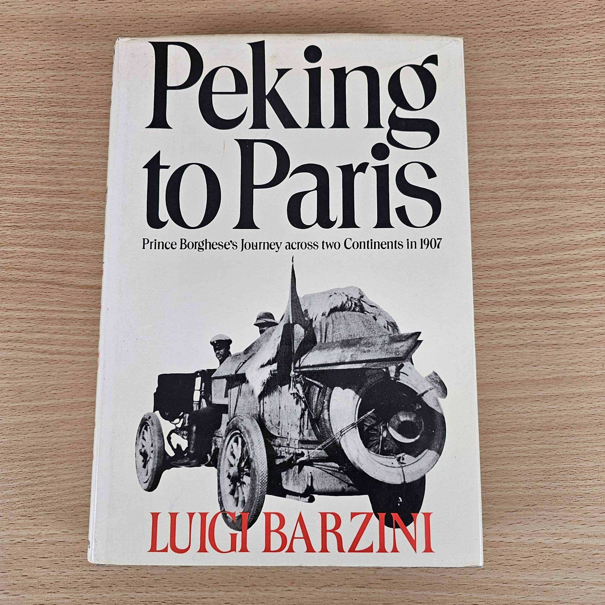 Hardcover book cover, Peking to Paris by Luigi Barzini, car and riders graphic