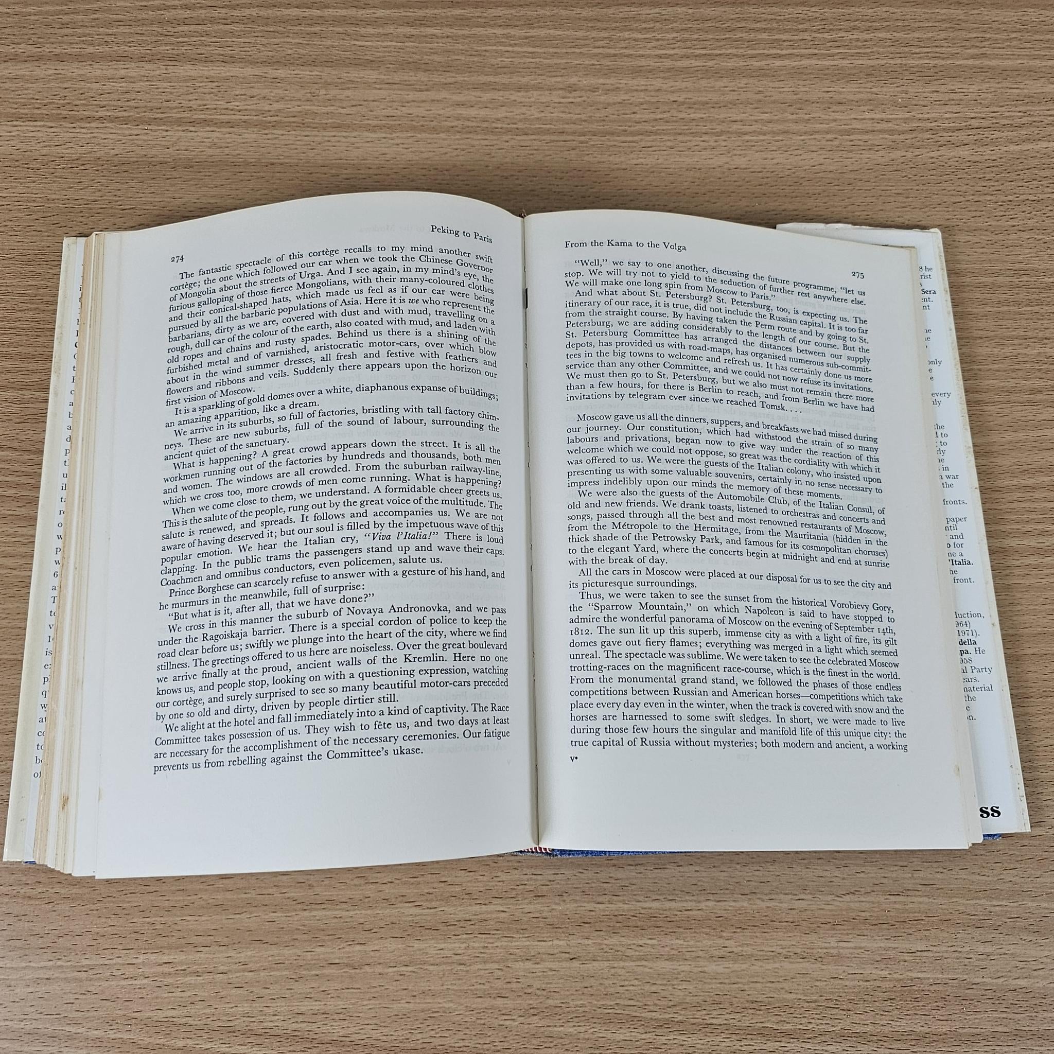 Hardcover book open to dense text pages with page numbers