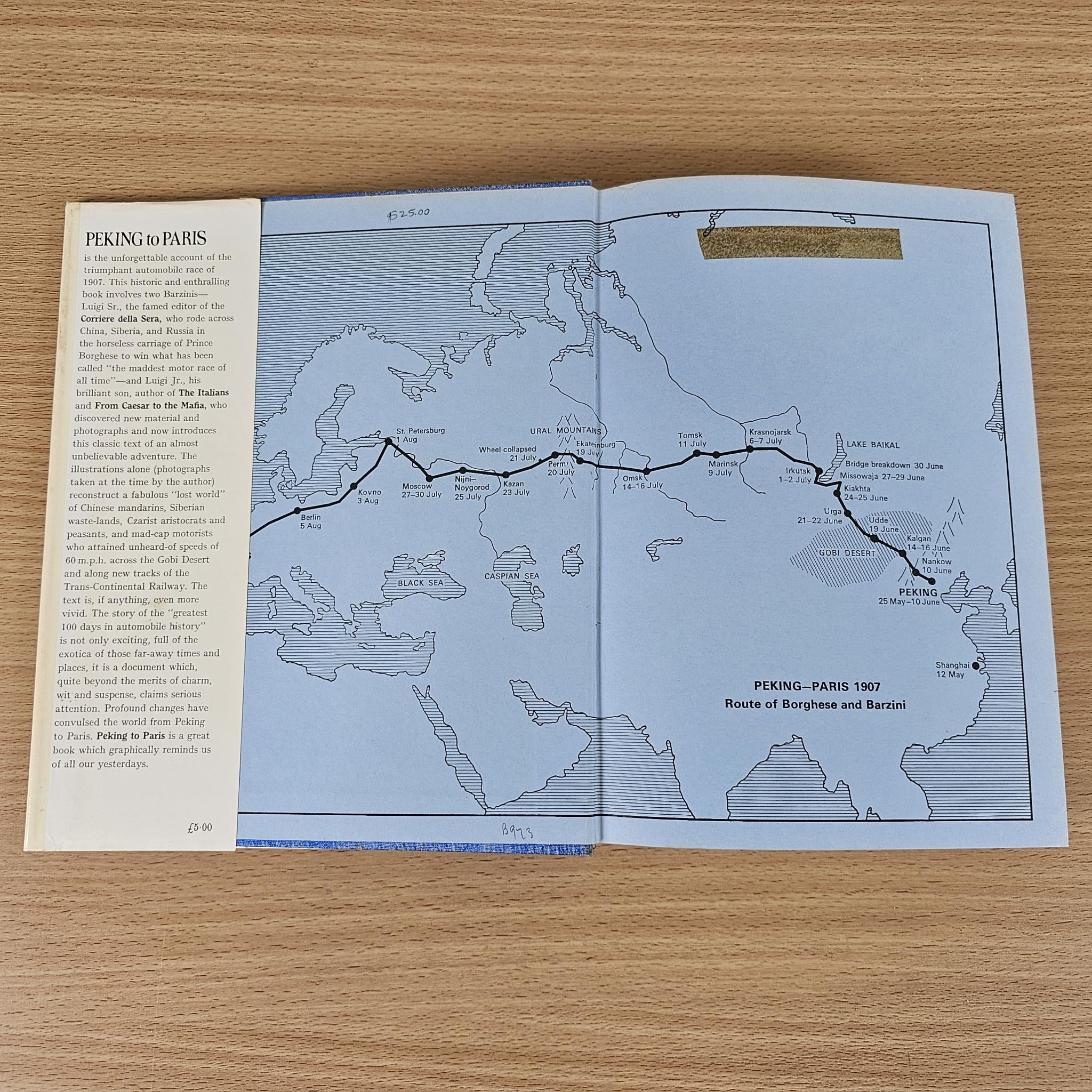 Hardcover book open to map spread showing a travel route across continents