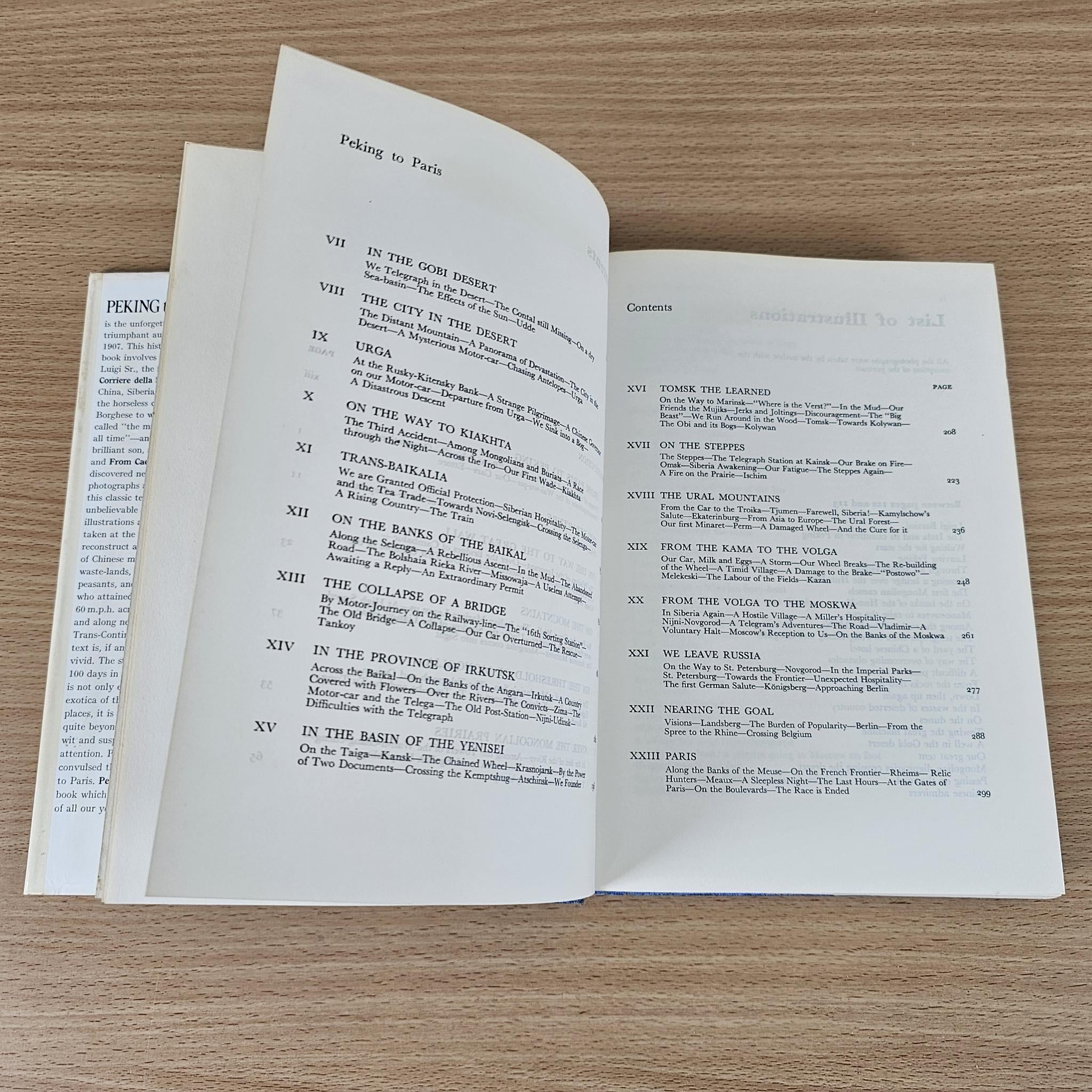 Hardcover book open to text pages with roman-numeral headings and paragraphs