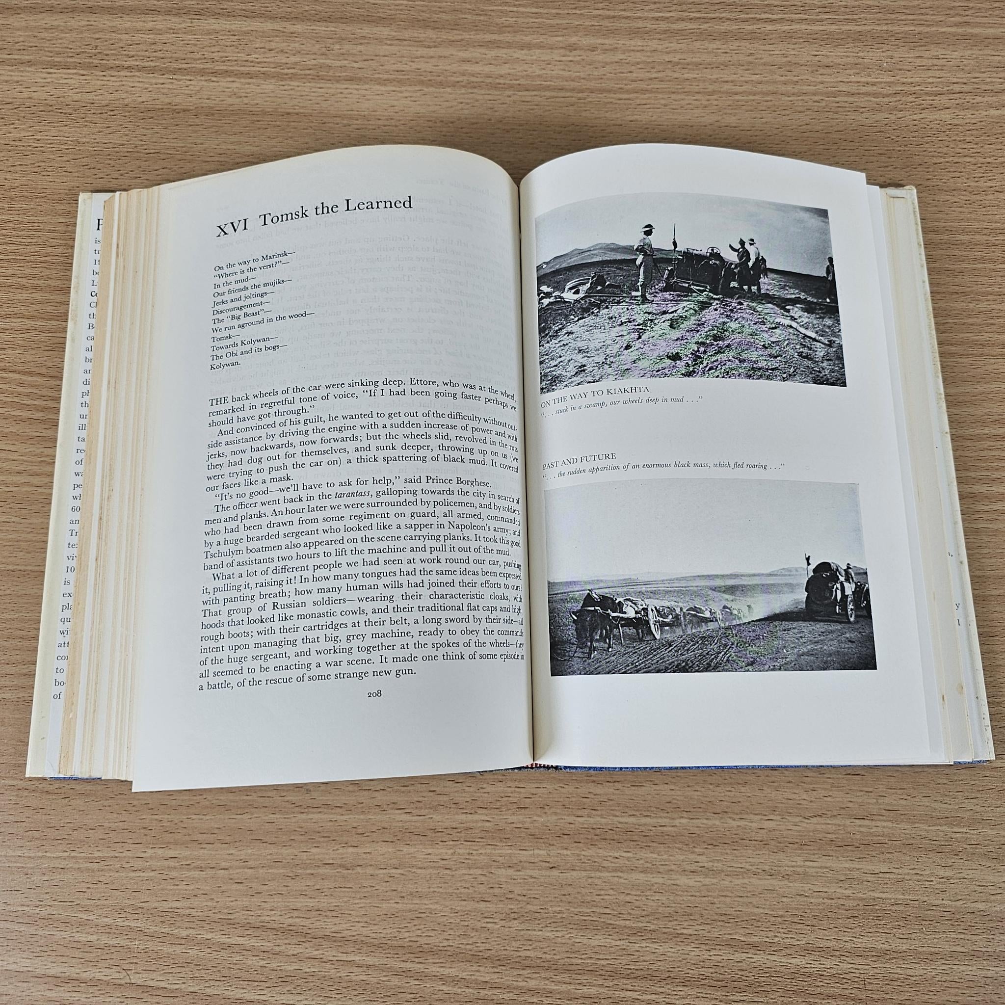 Hardcover book open to chapter text with two black-and-white landscape photos