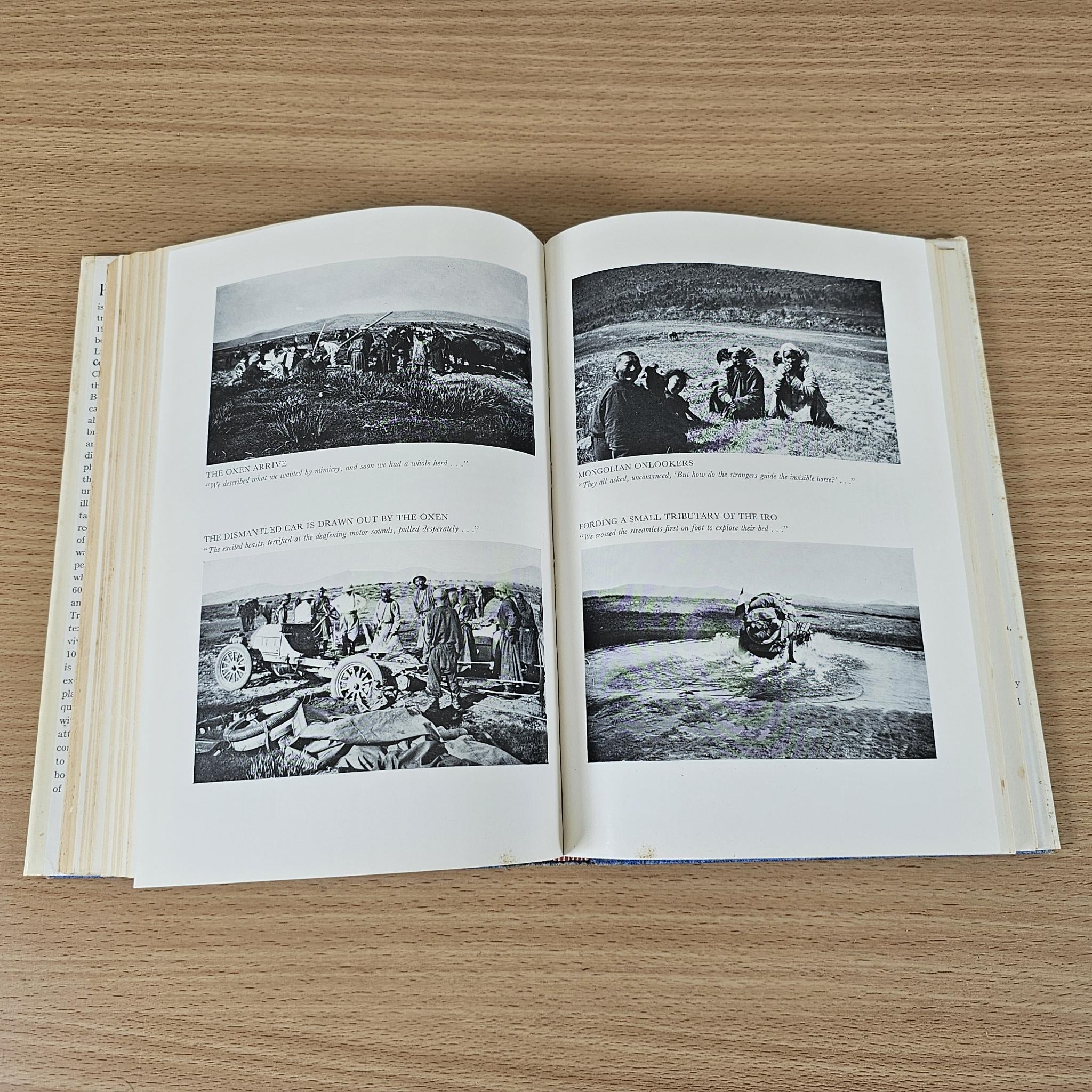 Hardcover book open to photo pages with black-and-white images and captions