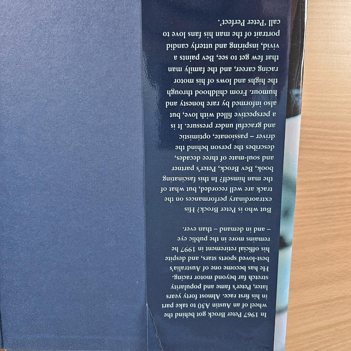 Close-up of printed text on a blue page from a hardcover book