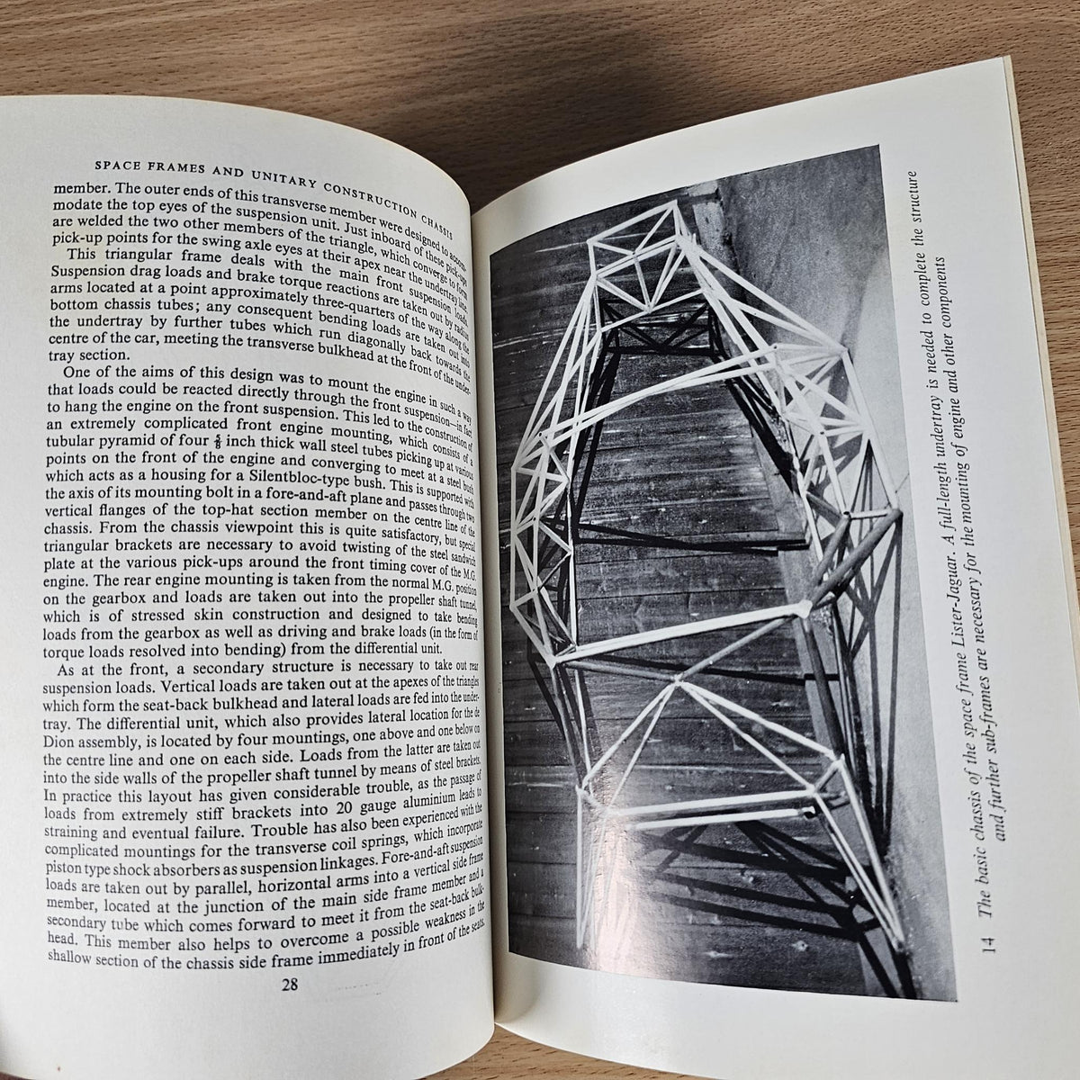 Open hardcover book with black-and-white chassis diagram across two pages
