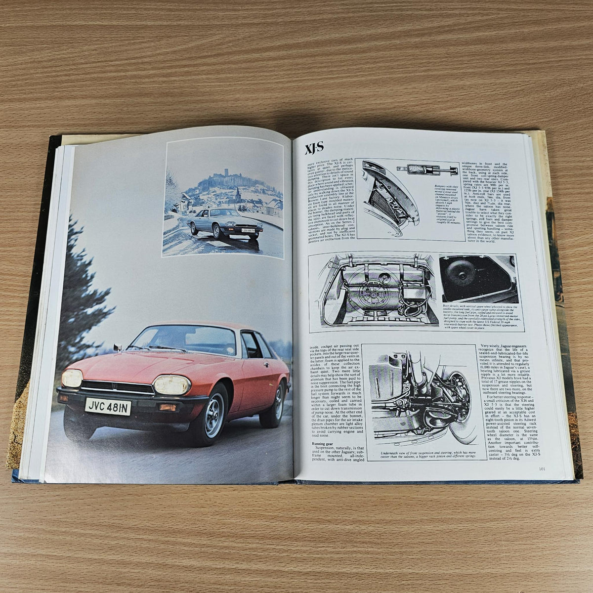 Open Jaguar sports book with car photos and technical article pages