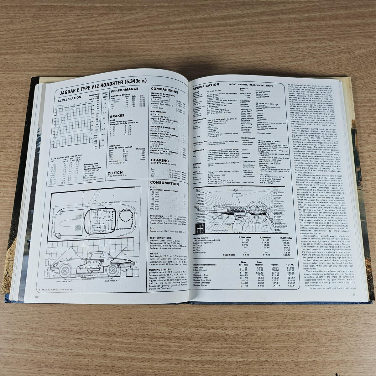 Open Jaguar sports book showing specification tables and engine diagrams