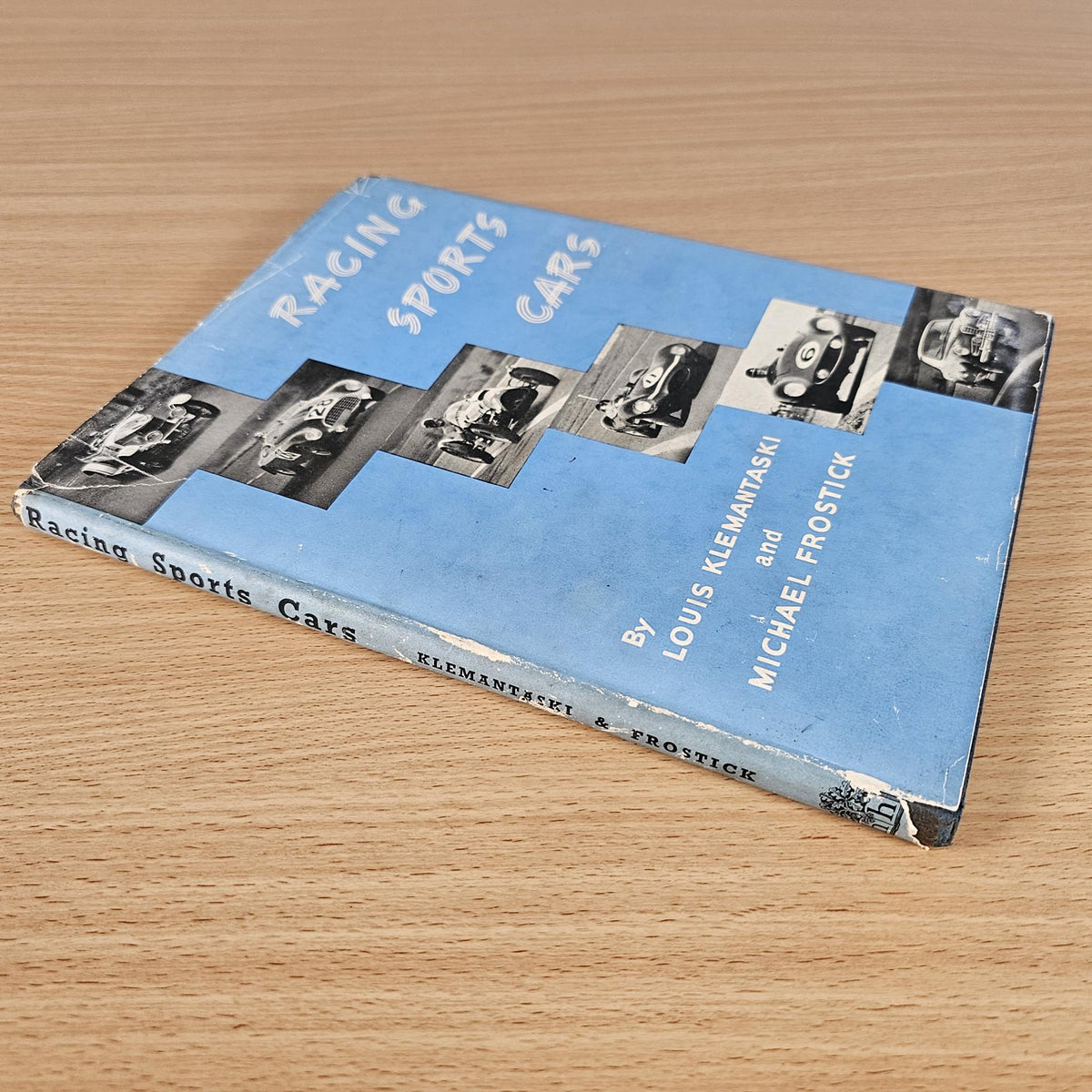 Vintage racing sports cars book, blue cover with car photos and author names on spine