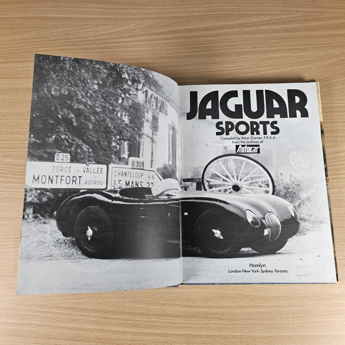 Open Jaguar Sports book spread with black-and-white race car photo and Jaguar heading