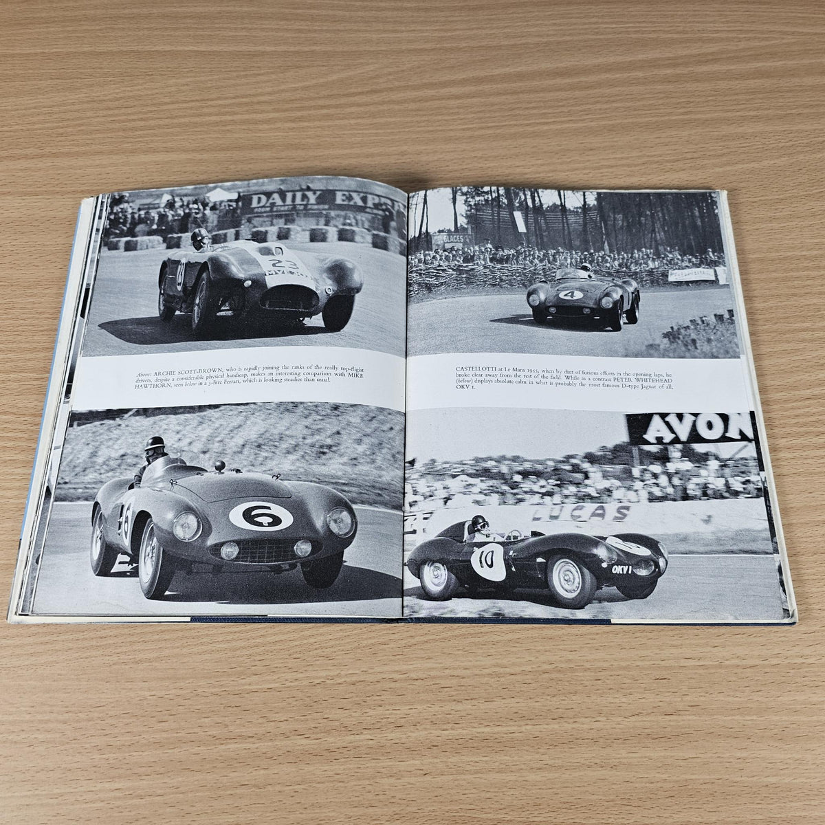 Open vintage racing sports cars book with four black-and-white car photos on facing pages
