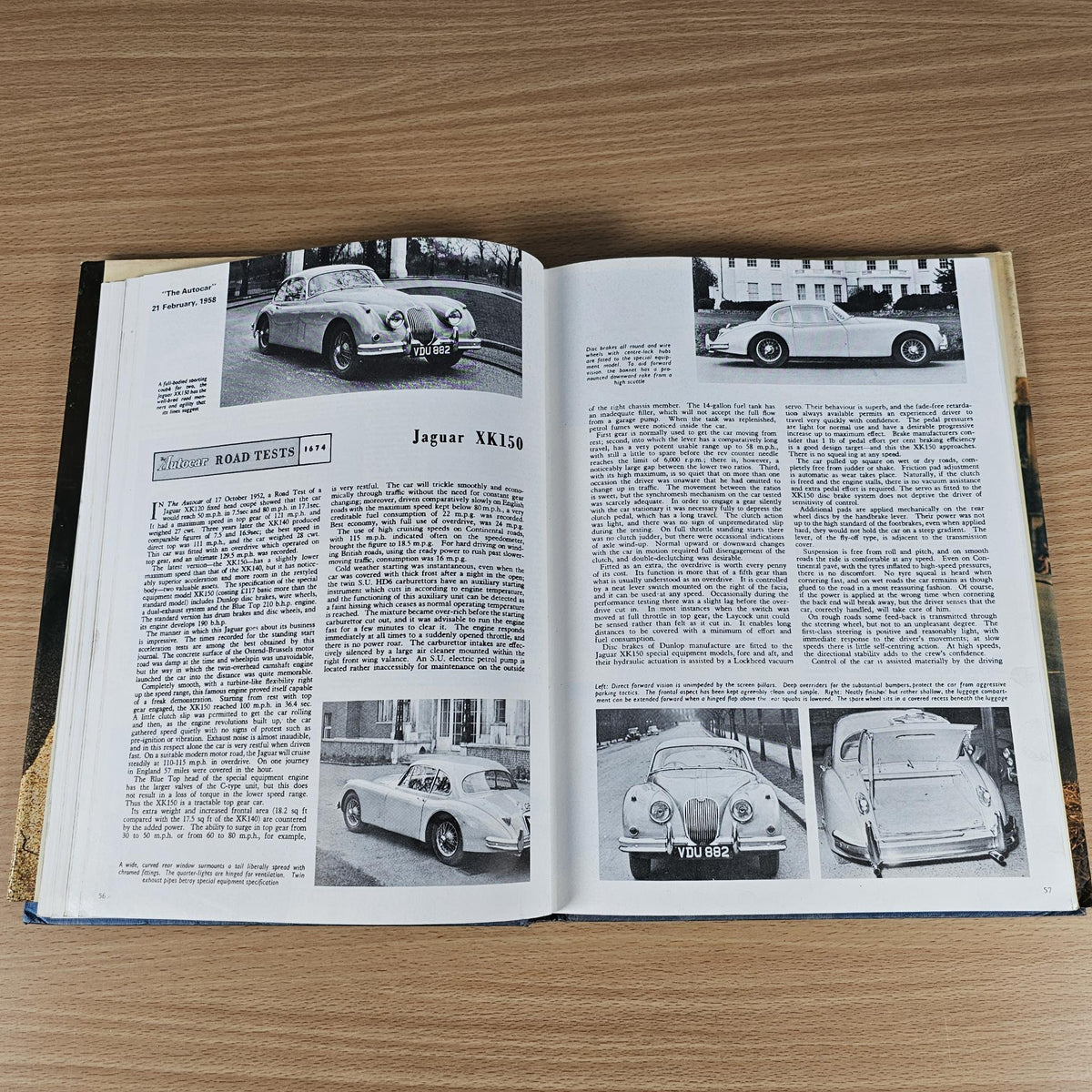 Open vintage car book spread with black-and-white road test photos and captions