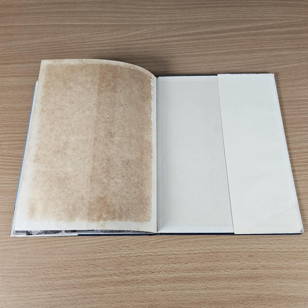 Vintage hardcover racing sports cars book opened to blank and lightly stained pages