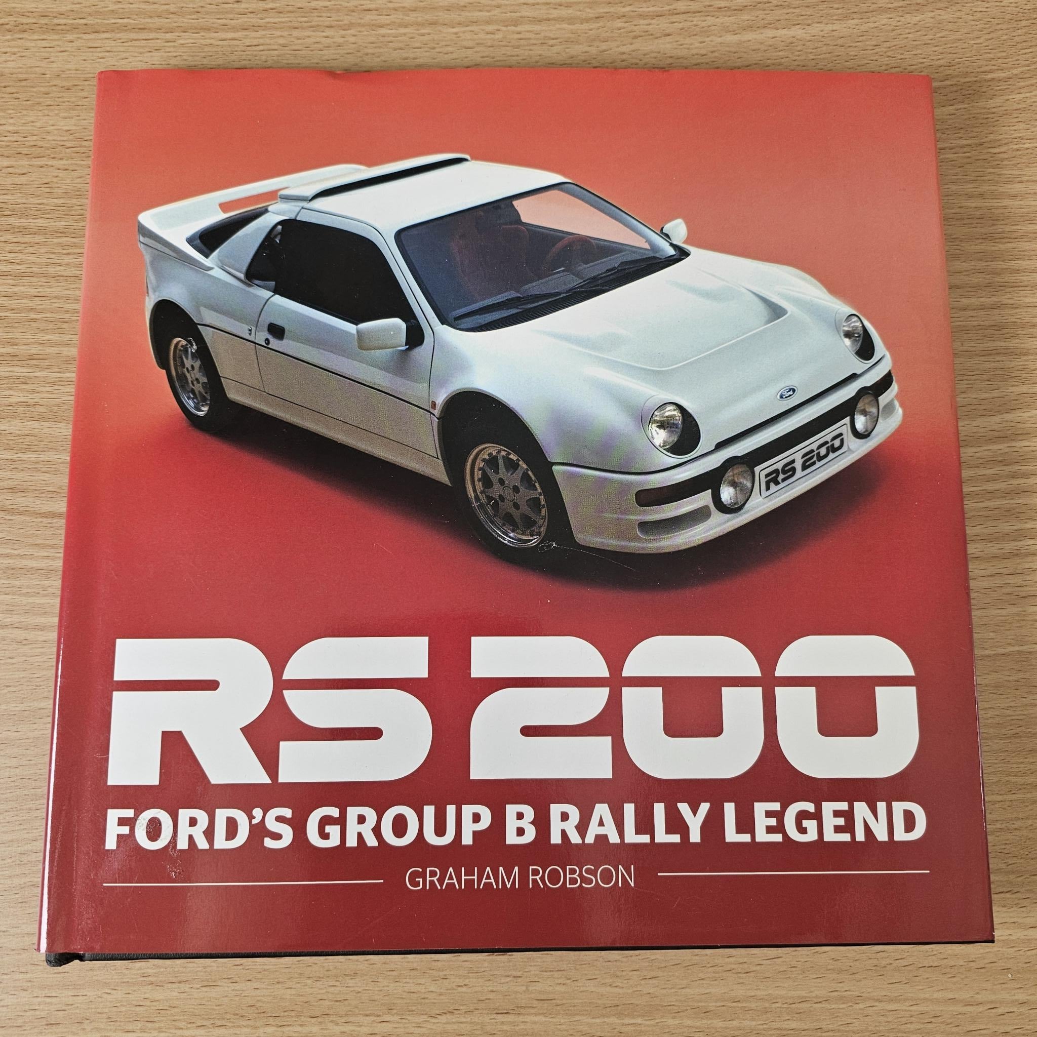 Rally legend book with red cover and silver sports car photo, RS200 text.