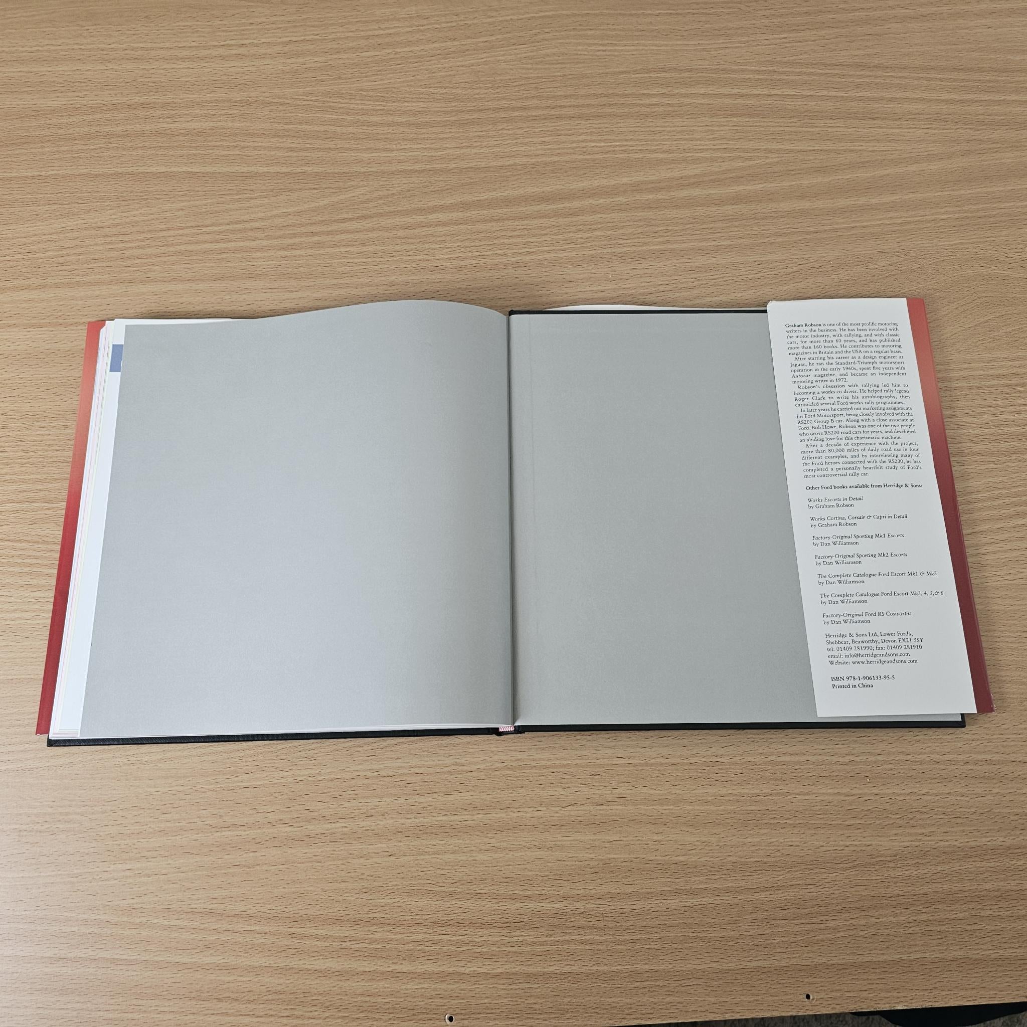 Open rally book with mostly blank gray pages and a right page text block.