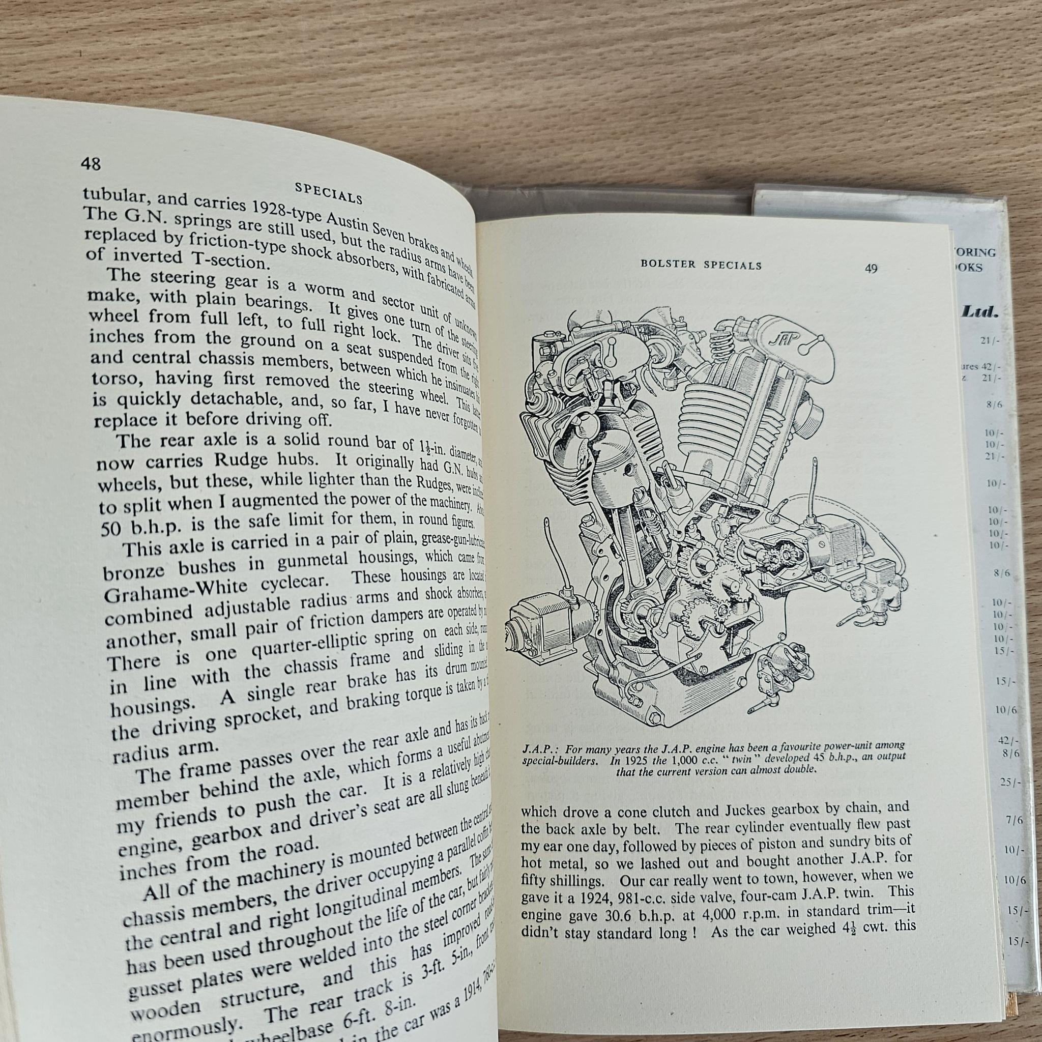Open book page with vintage racing car illustration and technical text.