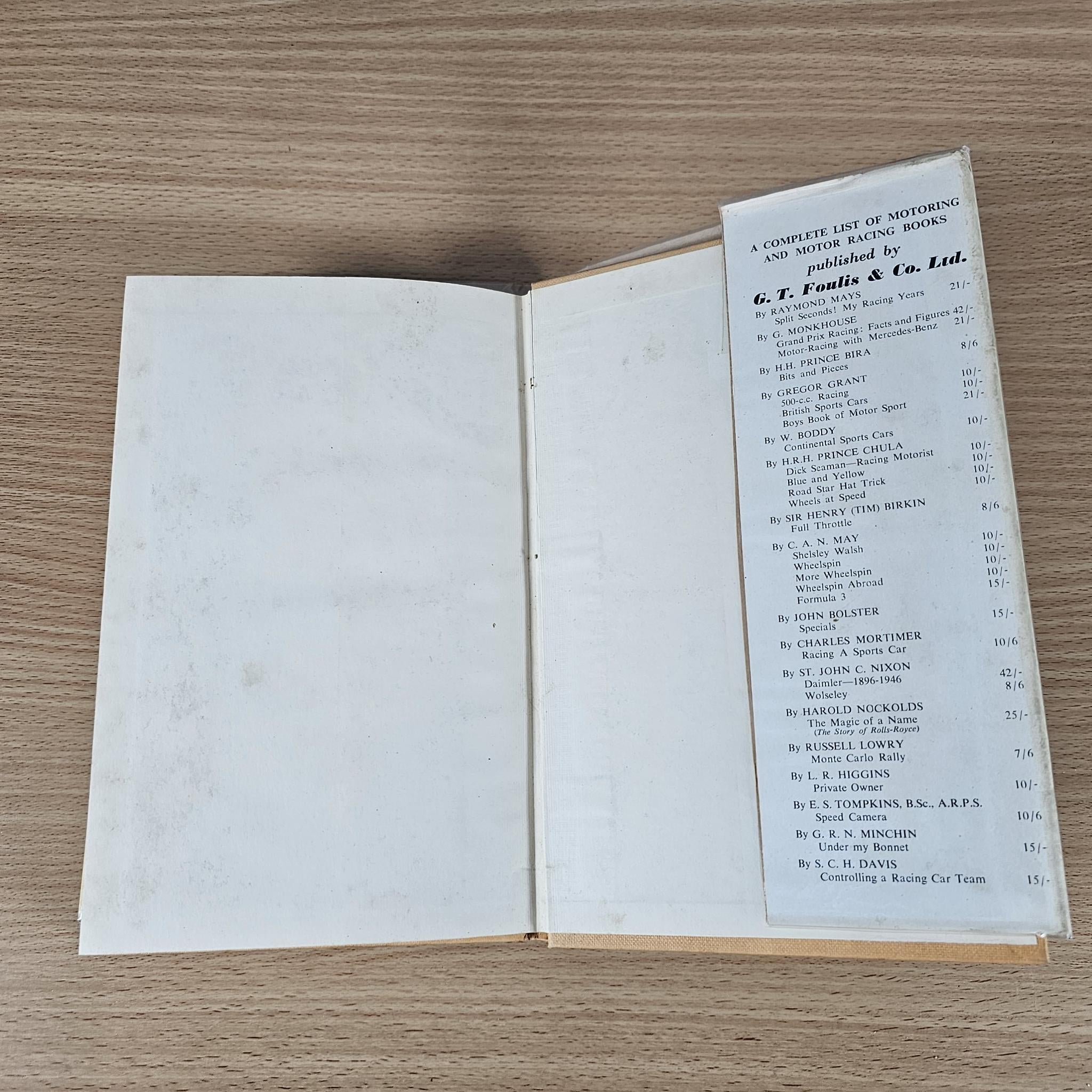 Open book with blank pages and a list table of names and car entries.