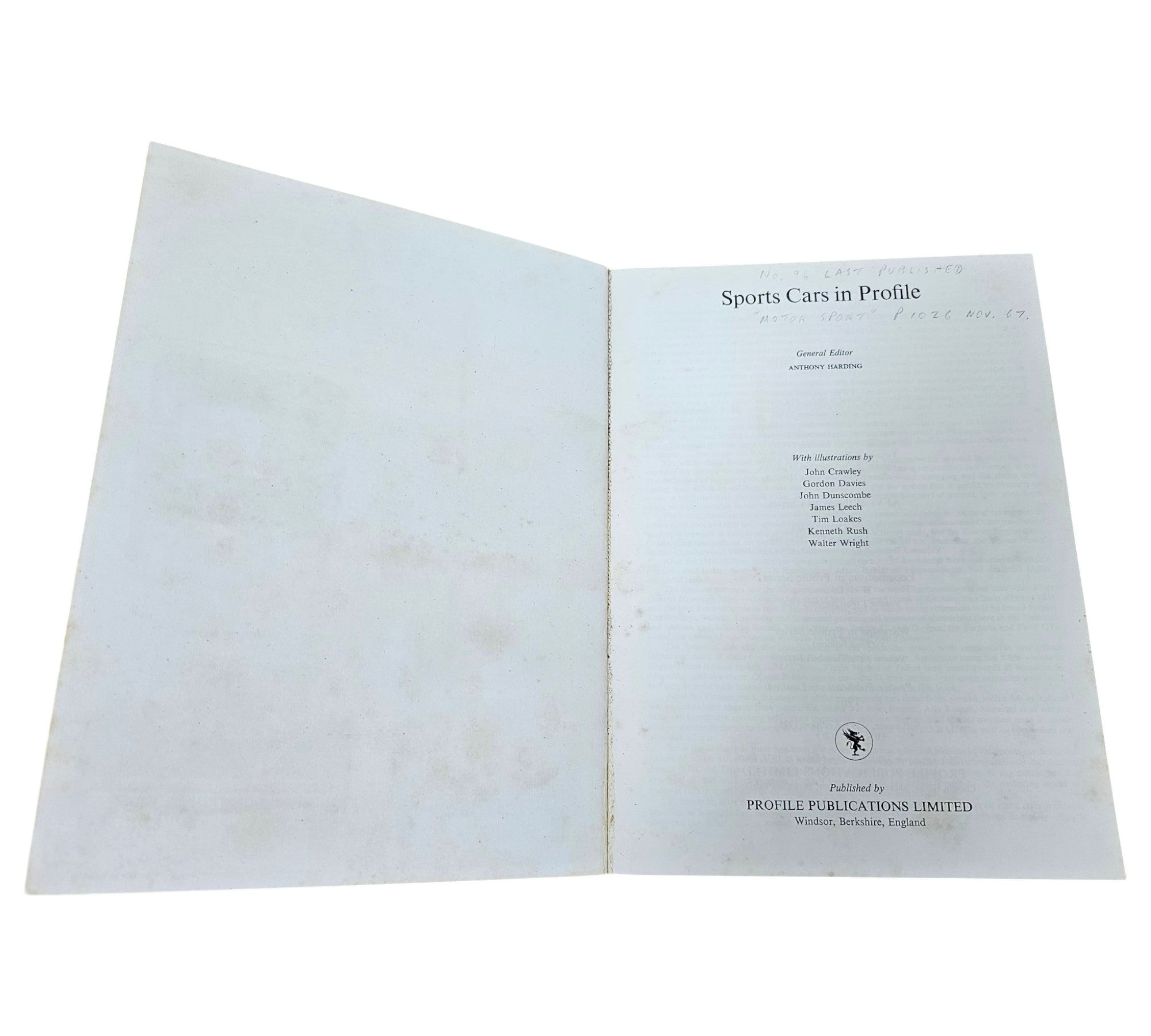 Open book with blank left page and typed title and publication details on right page.