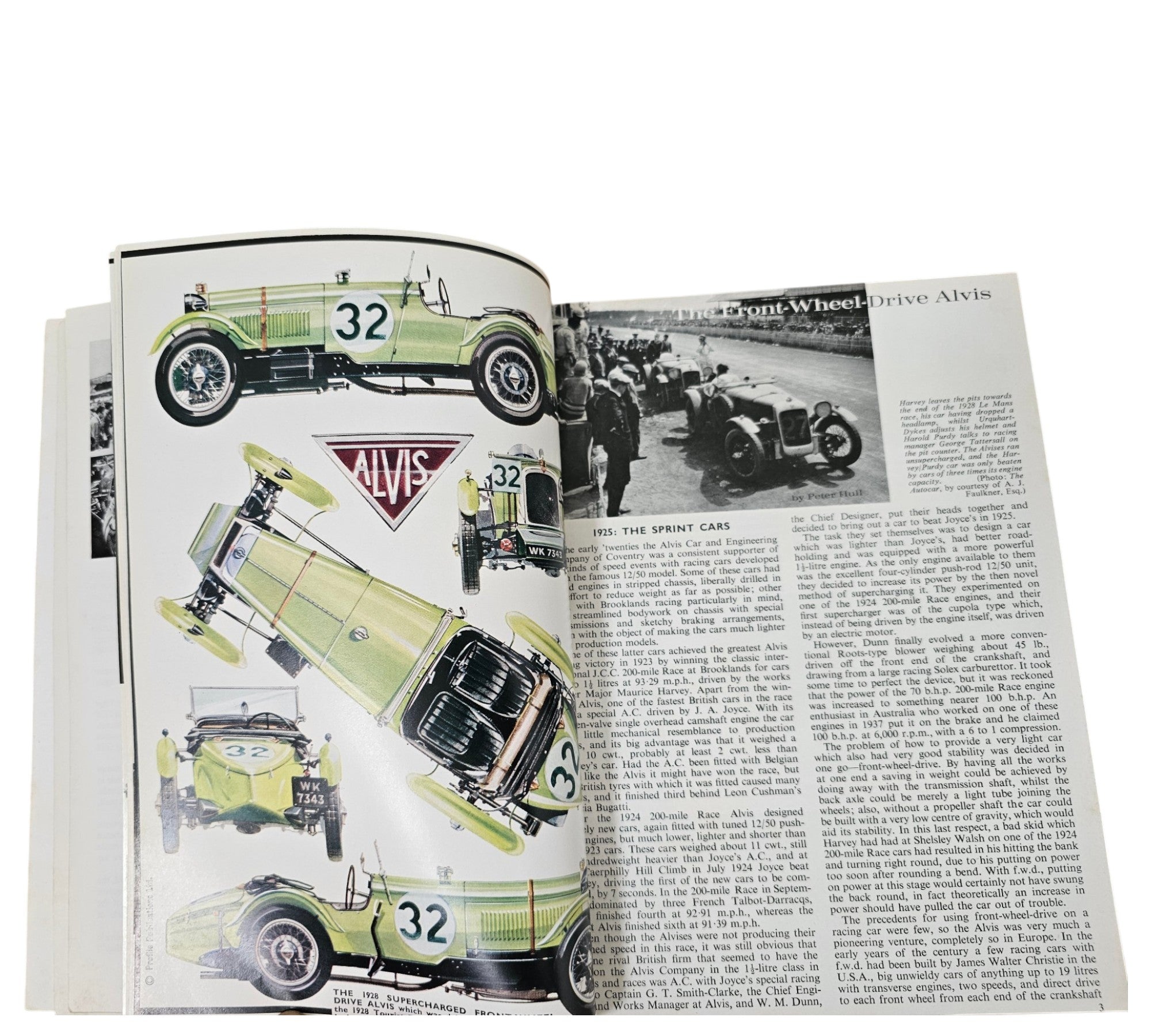 Open book spread with vintage race car diagrams and dense technical text.